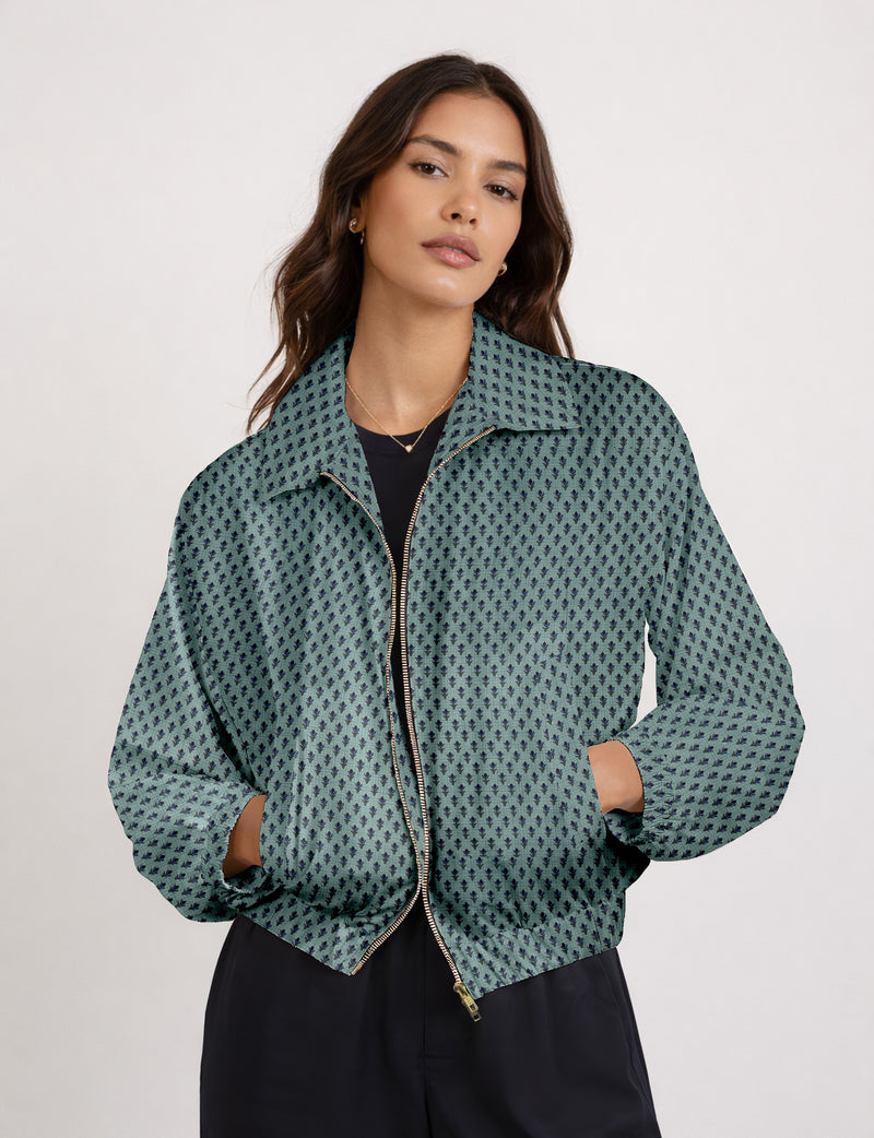 Brown floral bomber jacket with front zipper, elastic cuffs and hem, hanging on white hanger, red floral inner lining visible