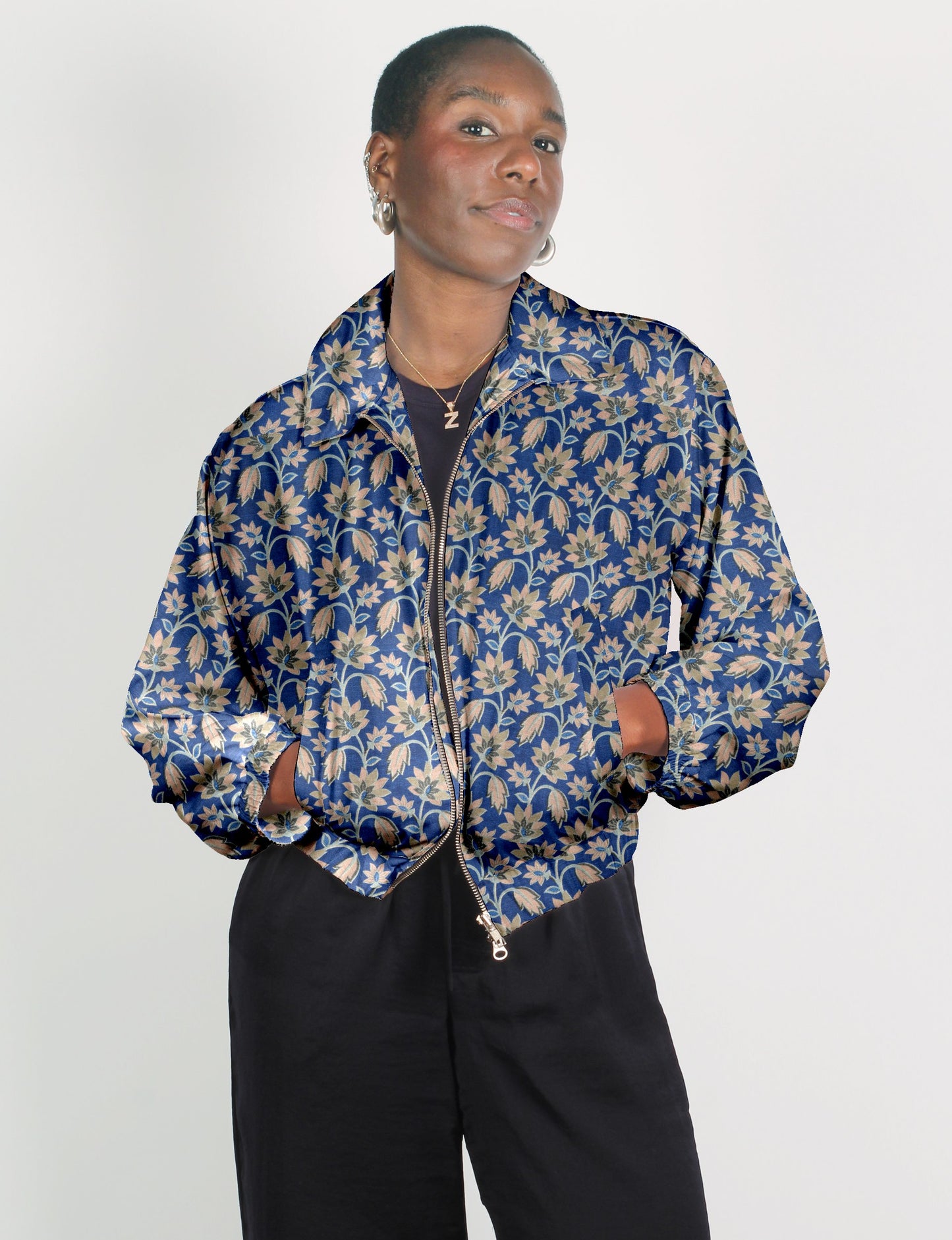 Upcycled Bomber Jacket made from recycled sari materials, featuring a cute cropped shape, elasticated hem and cuffs, and contrast sari print lining. Sustainable apparel promoting eco-friendly fashion and ethical clothing.