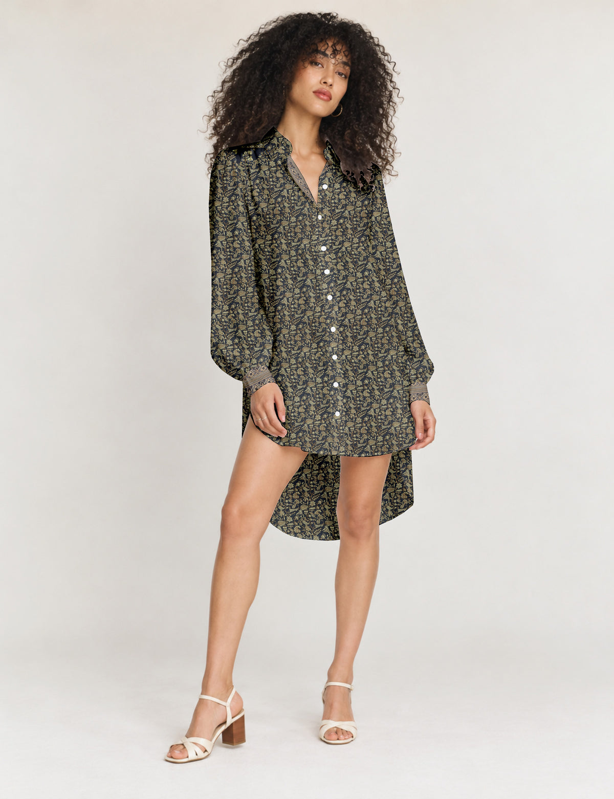 High low shirt with a relaxed fit, button-down front, classic collar, gathered shoulders and full-length blouson sleeves.