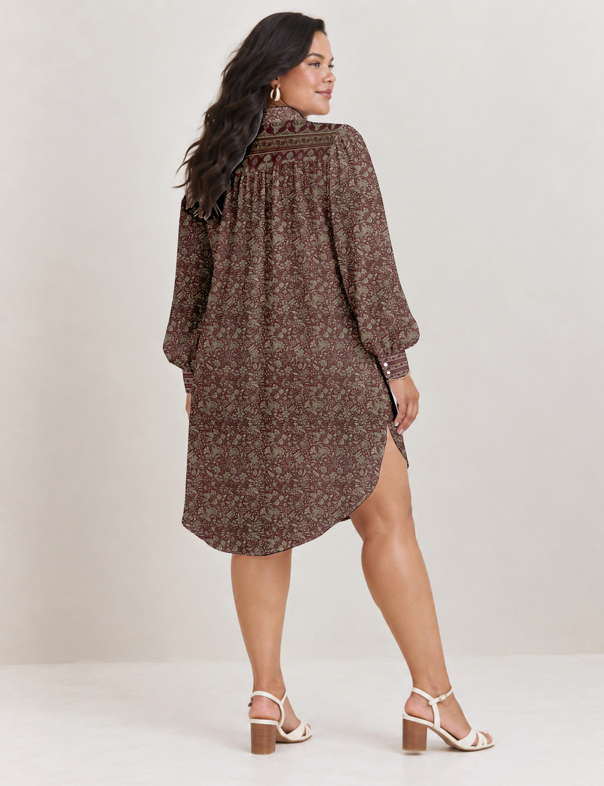 High low shirt with a relaxed fit, button-down front, classic collar, gathered shoulders and full-length blouson sleeves.