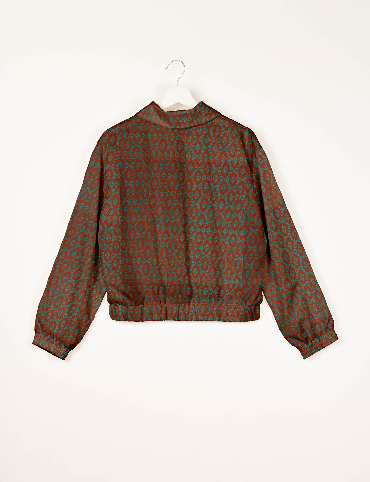 Brown bomber jacket with teal Indian ethnic pattern, elastic cuffs and waistband, shown from back on white hanger