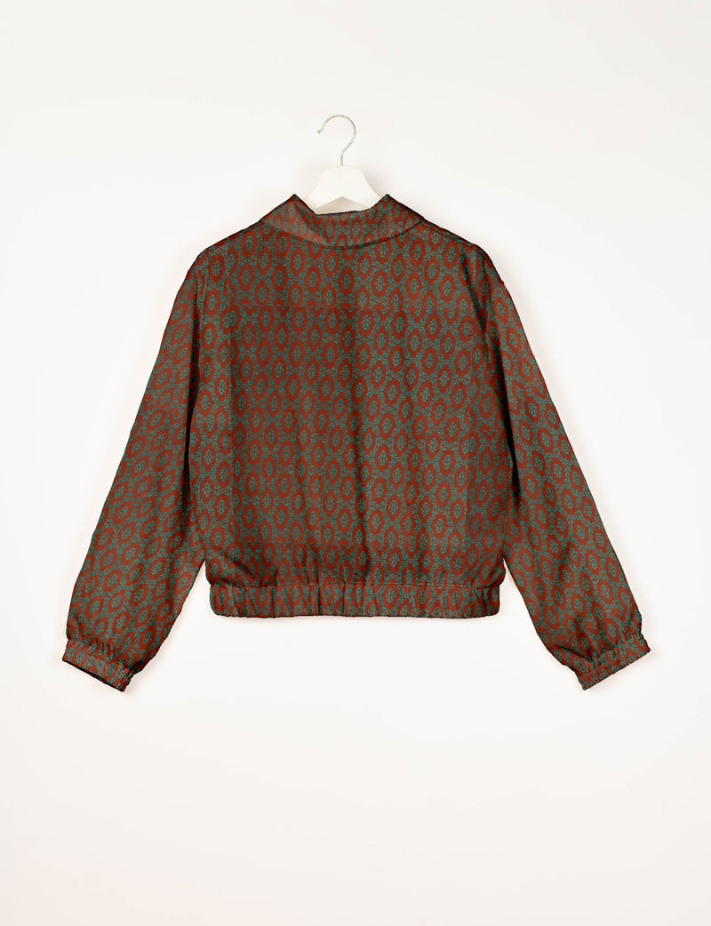 Brown bomber jacket with teal Indian ethnic pattern, elastic cuffs and waistband, shown from back on white hanger