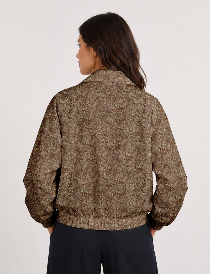 Woman wearing a yellow floral bomber jacket with front zipper, elastic cuffs, and side pockets, shown from front view