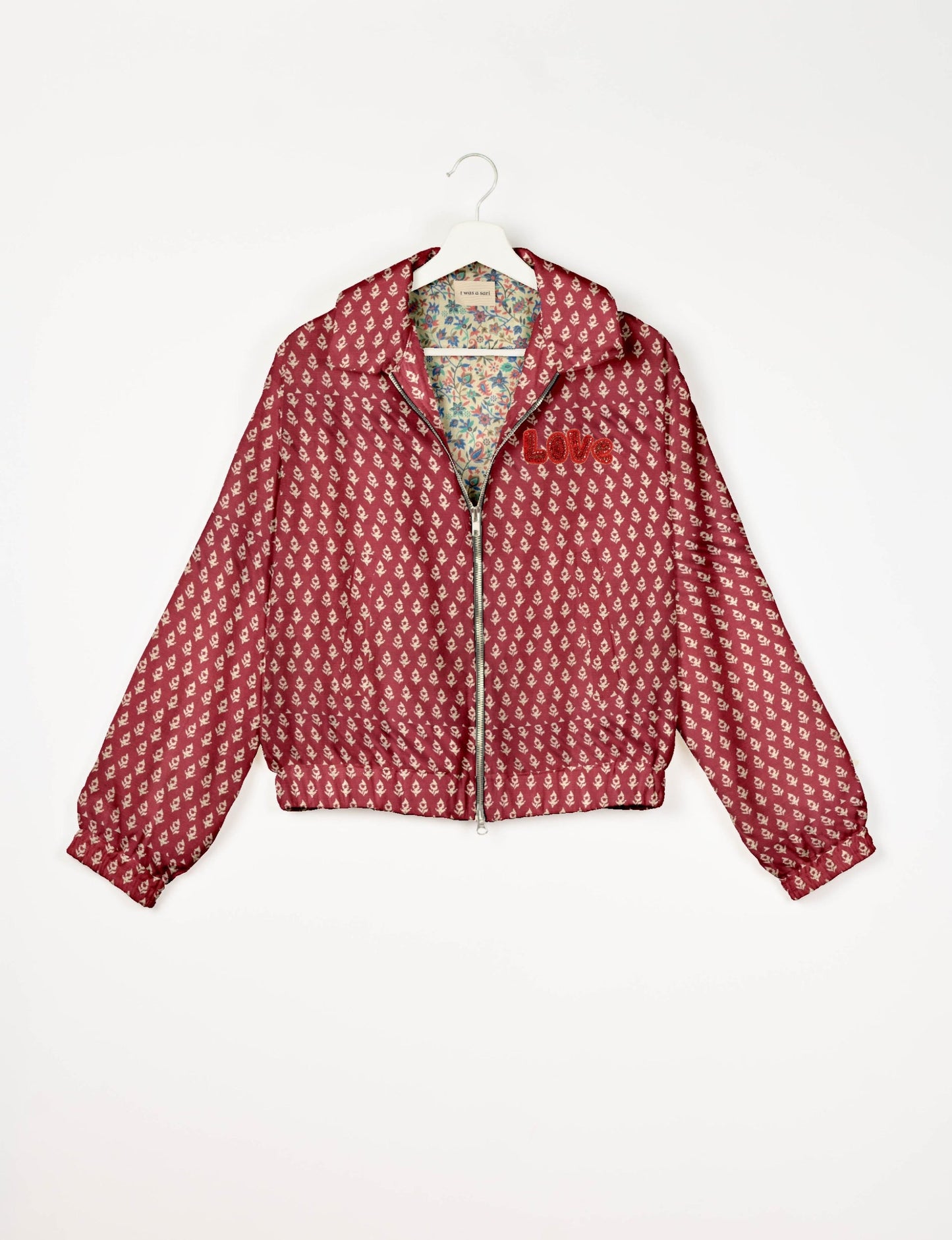 Love Bomber Jacket made from recycled fabric, featuring hand-stitched Aari embroidery. A unique piece of zero-waste clothing, part of the circular fashion movement. Designed with upcycled materials for a stylish yet environmentally friendly clothing choice.