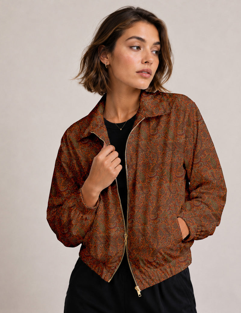 Brown floral bomber jacket with front zipper, elastic cuffs and hem, hanging on white hanger, red floral inner lining visible