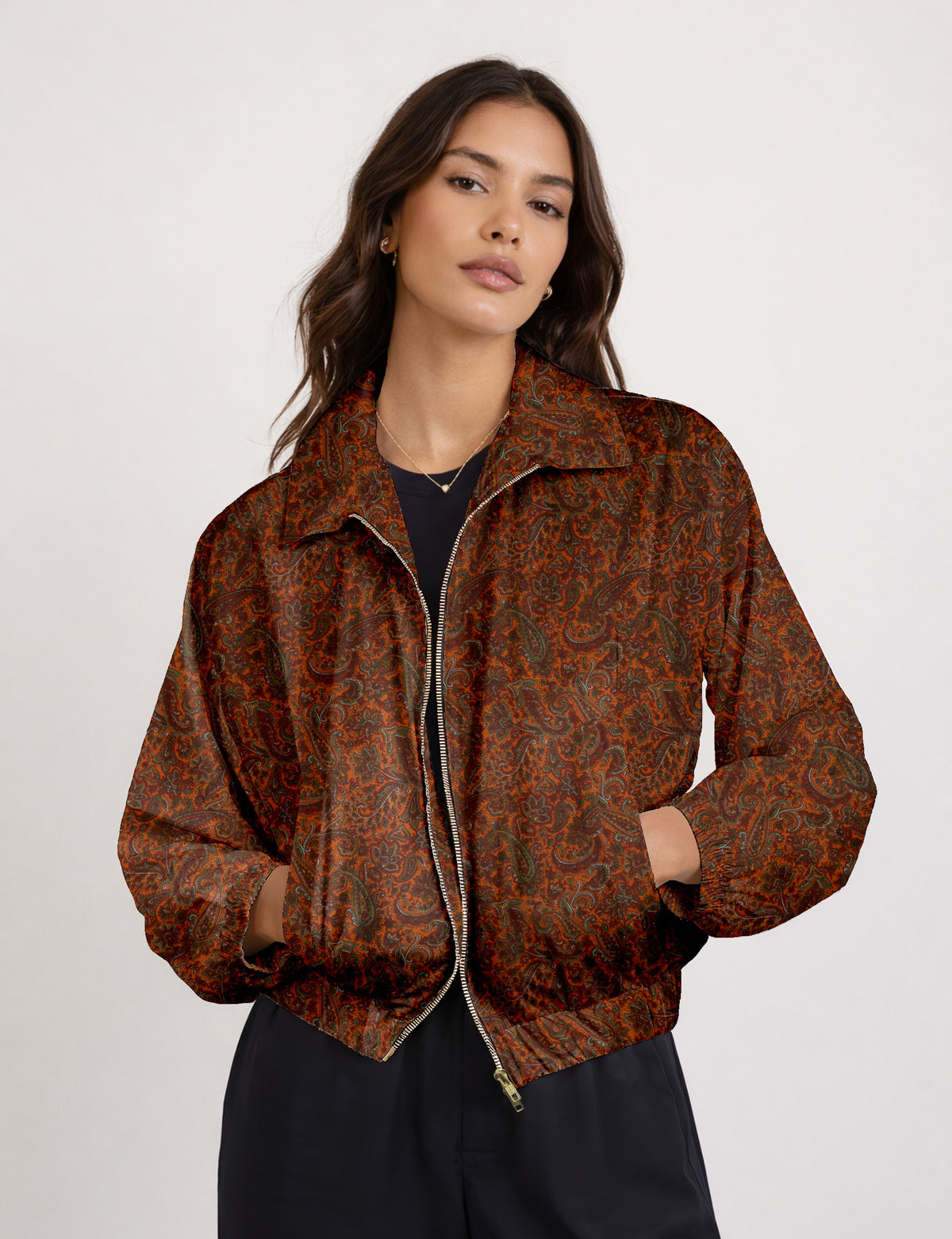 Woman wearing a yellow floral bomber jacket with front zipper, elastic cuffs, and side pockets, shown from front view
