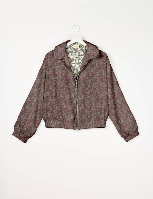 Stylish BOMBER JACKET, an upcycled clothing masterpiece with a cute cropped shape, elasticated details, and detachable metallic zipper. Contrast sari print lining adds a unique touch. Explore sustainable and eco-friendly fashion.