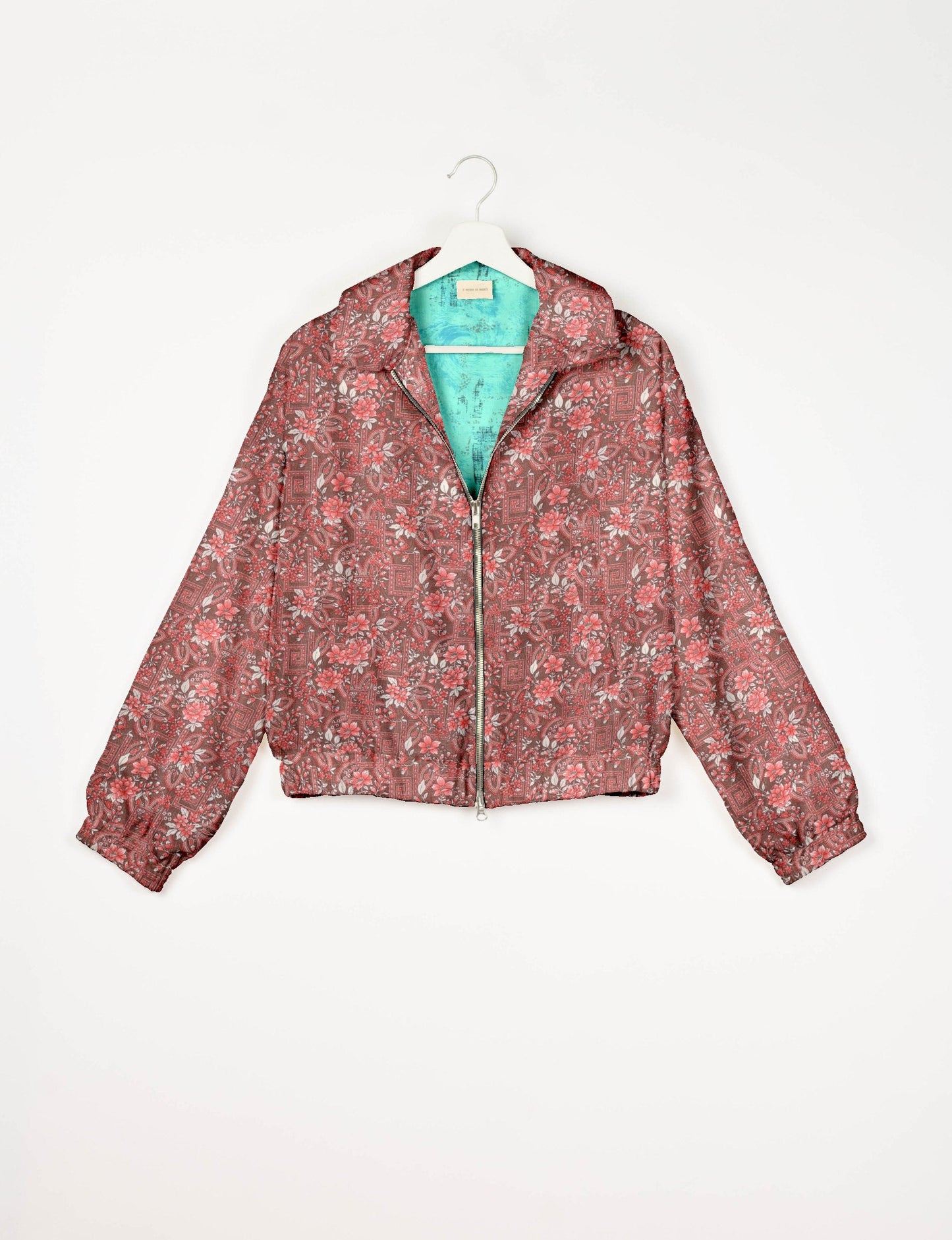 Stylish BOMBER JACKET, an upcycled clothing masterpiece with a cute cropped shape, elasticated details, and detachable metallic zipper. Contrast sari print lining adds a unique touch. Explore sustainable and eco-friendly fashion.