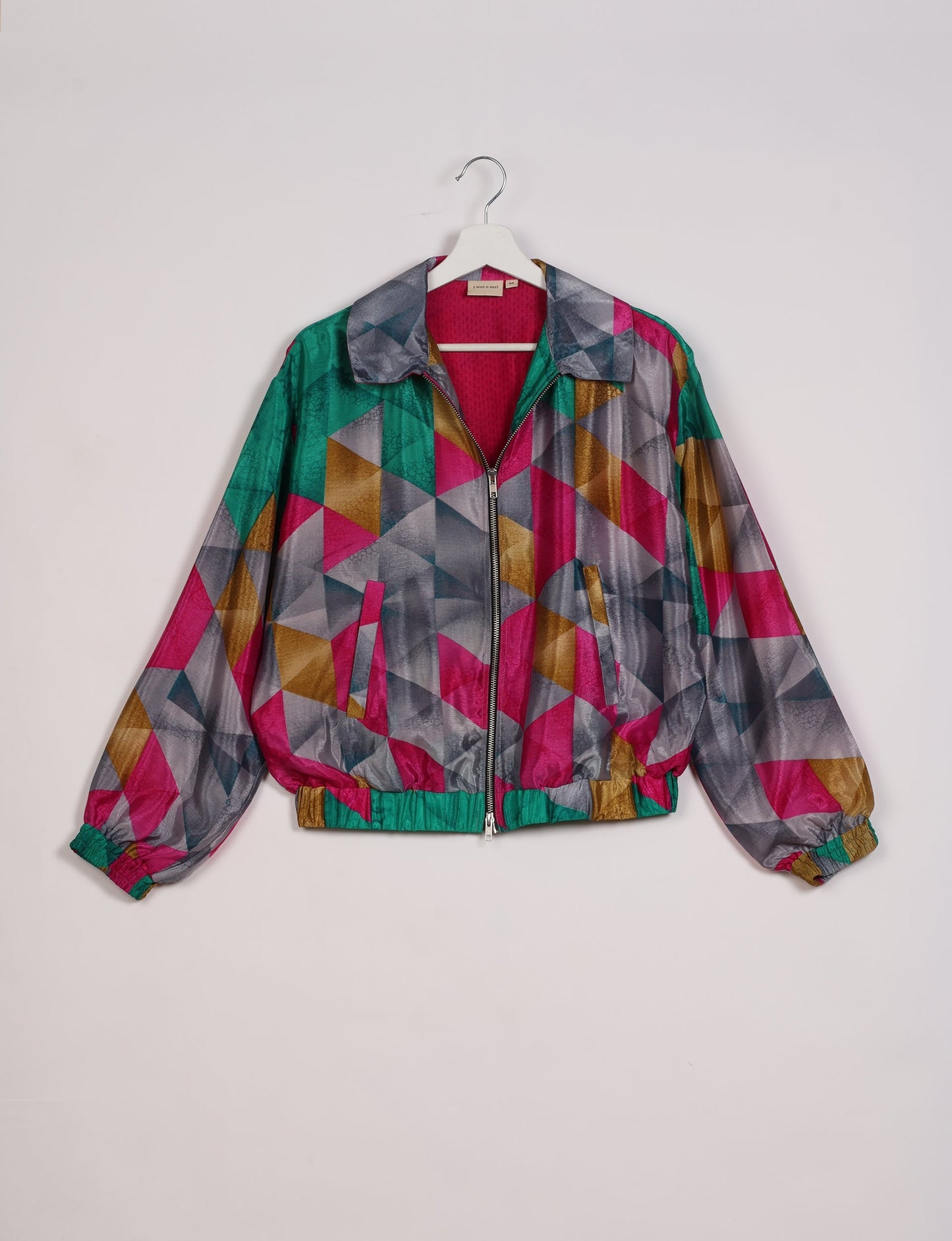 Stylish BOMBER JACKET, an upcycled clothing masterpiece with a cute cropped shape, elasticated details, and detachable metallic zipper. Contrast sari print lining adds a unique touch. Explore sustainable and eco-friendly fashion.