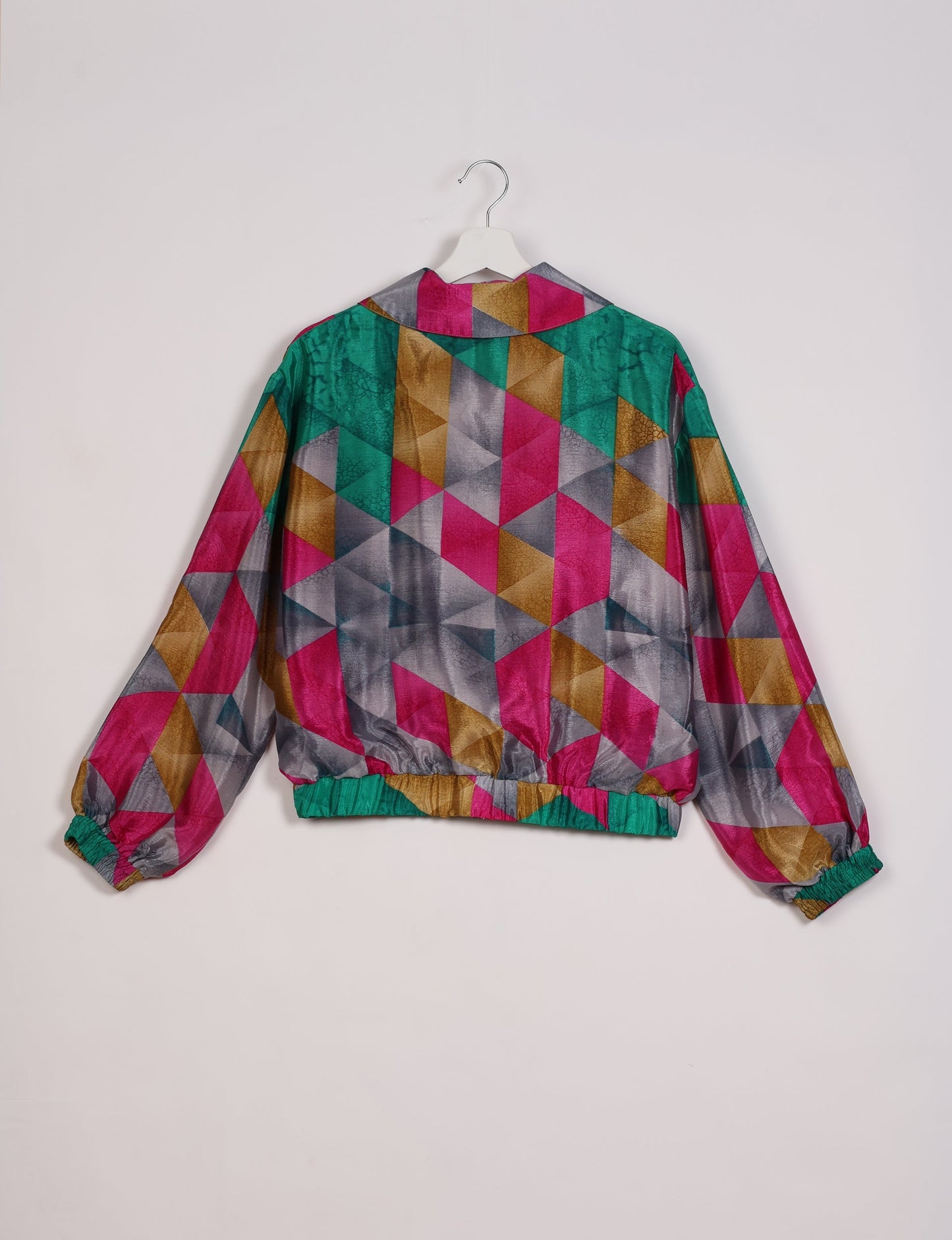 Stylish BOMBER JACKET, an upcycled clothing masterpiece with a cute cropped shape, elasticated details, and detachable metallic zipper. Contrast sari print lining adds a unique touch. Explore sustainable and eco-friendly fashion.