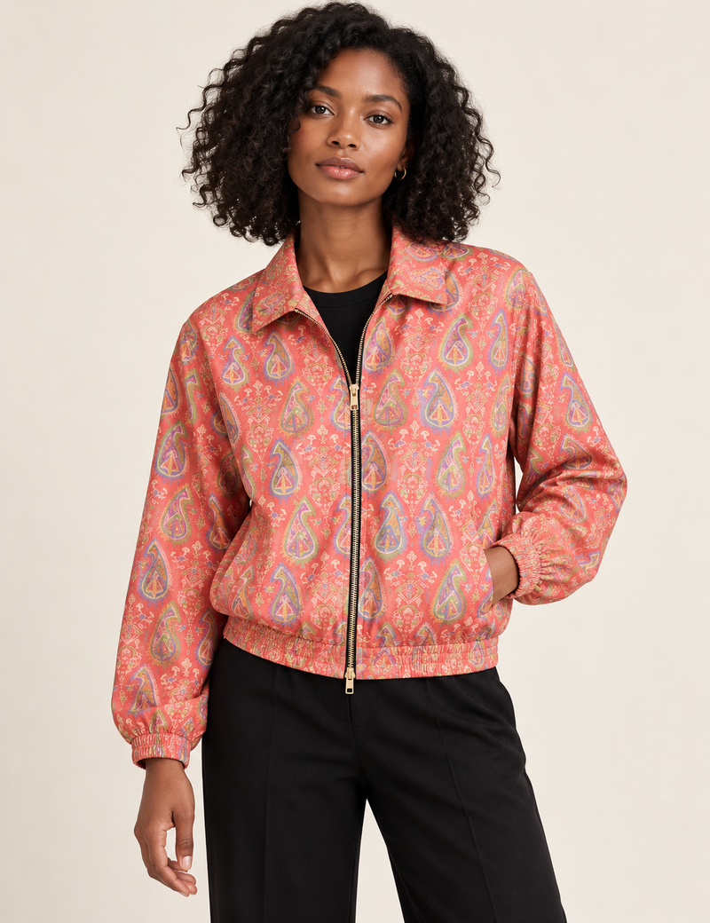 Woman wearing a yellow floral bomber jacket with front zipper, elastic cuffs, and side pockets, shown from front view