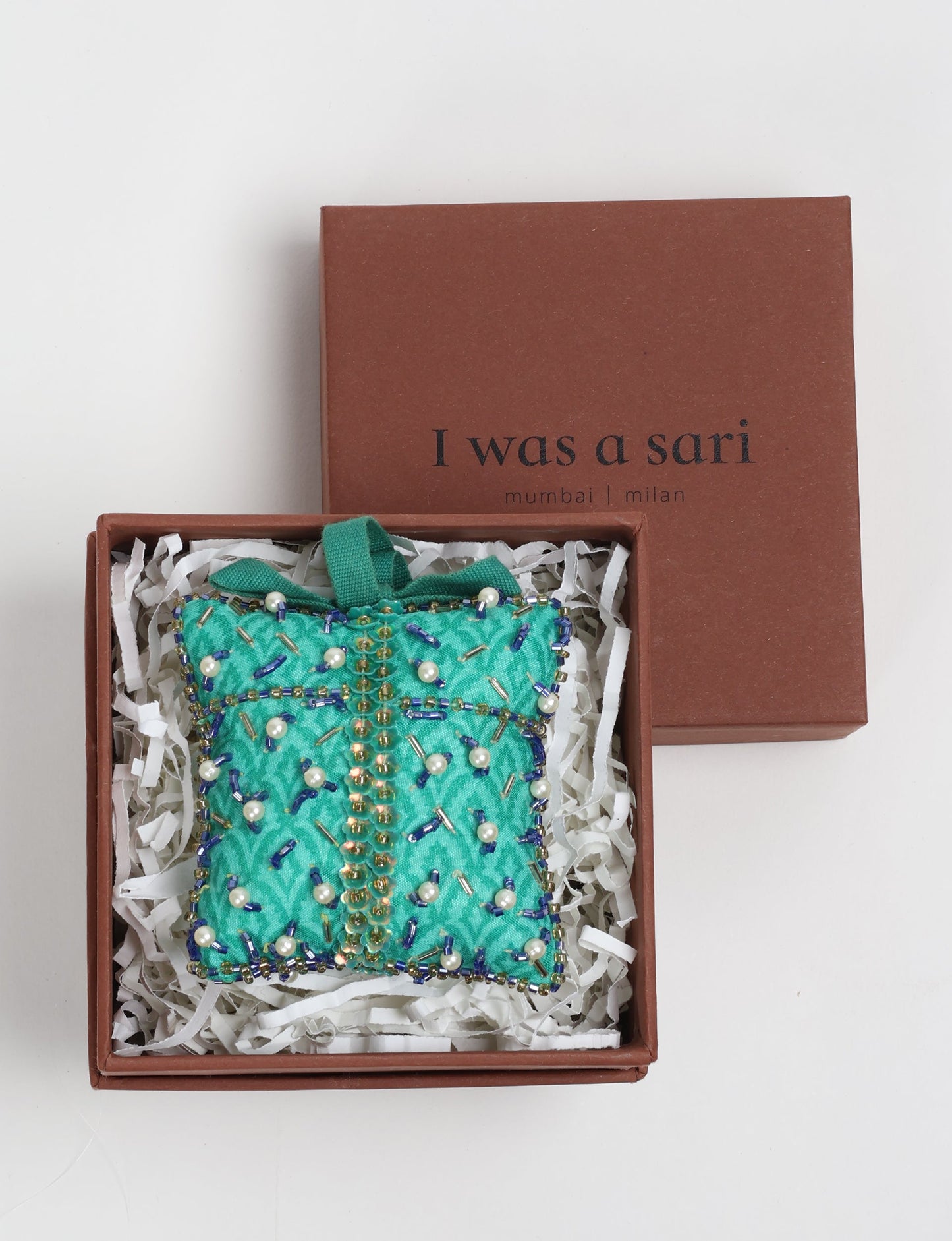 Eco-conscious Christmas ornament crafted from preloved saris, showcasing intricate Aari hand embroidery by female artisans. A beautiful, fair trade, upcycled decoration reflecting sustainable fashion, recycled materials, and ethical craftsmanship in green, earth-friendly, and circular fashion.