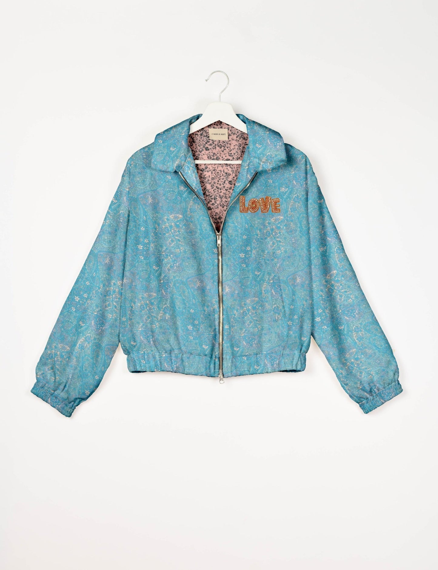 Love Bomber Jacket made from recycled fabric, featuring hand-stitched Aari embroidery. A unique piece of zero-waste clothing, part of the circular fashion movement. Designed with upcycled materials for a stylish yet environmentally friendly clothing choice.