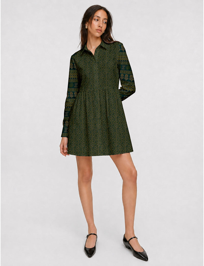 Short shirt dress with a relaxed A-line silhouette, point collar, partial button placket, gathered waist, side pockets, and full-length cuffed sleeves.