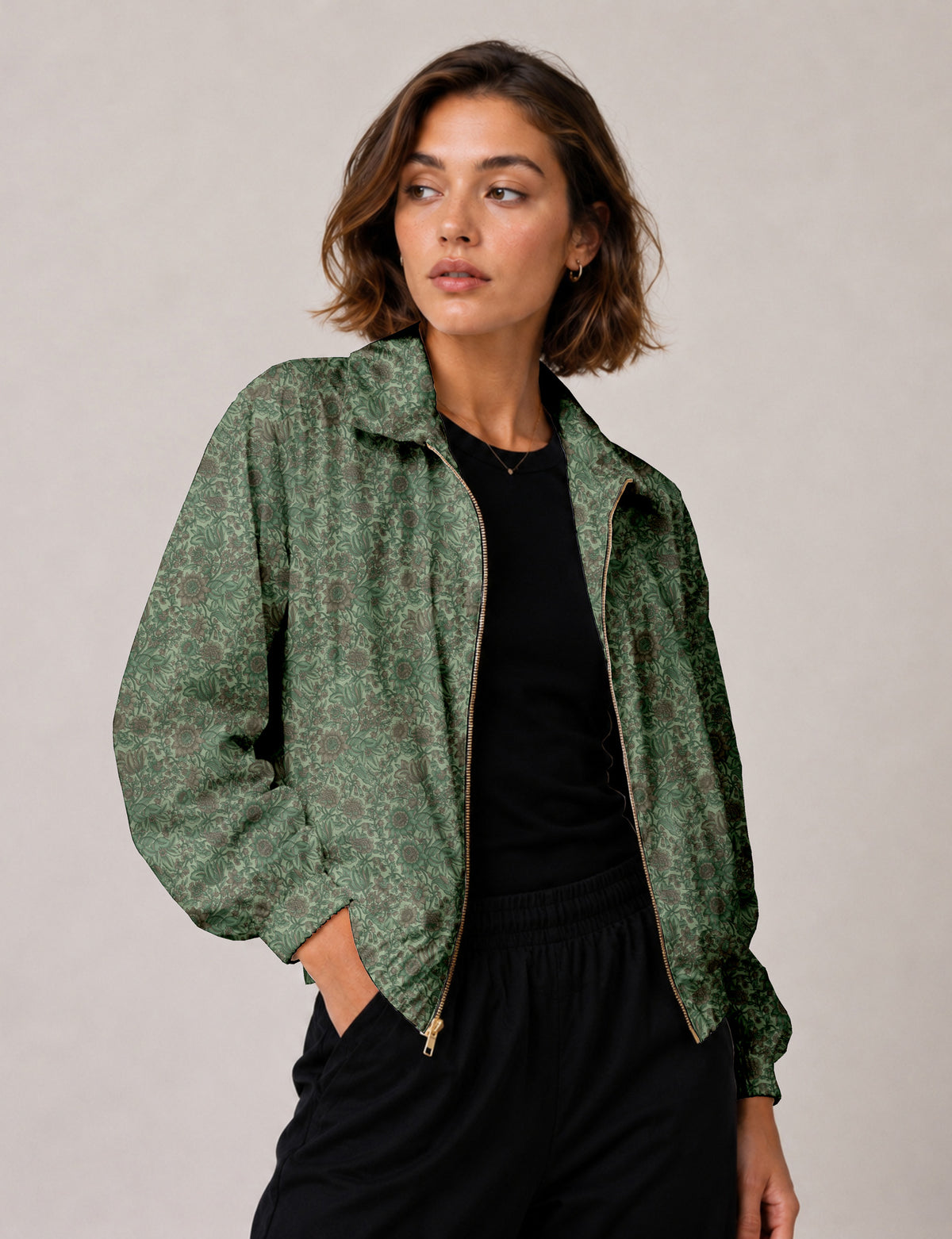 Woman wearing a yellow floral bomber jacket with front zipper, elastic cuffs, and side pockets, shown from front view