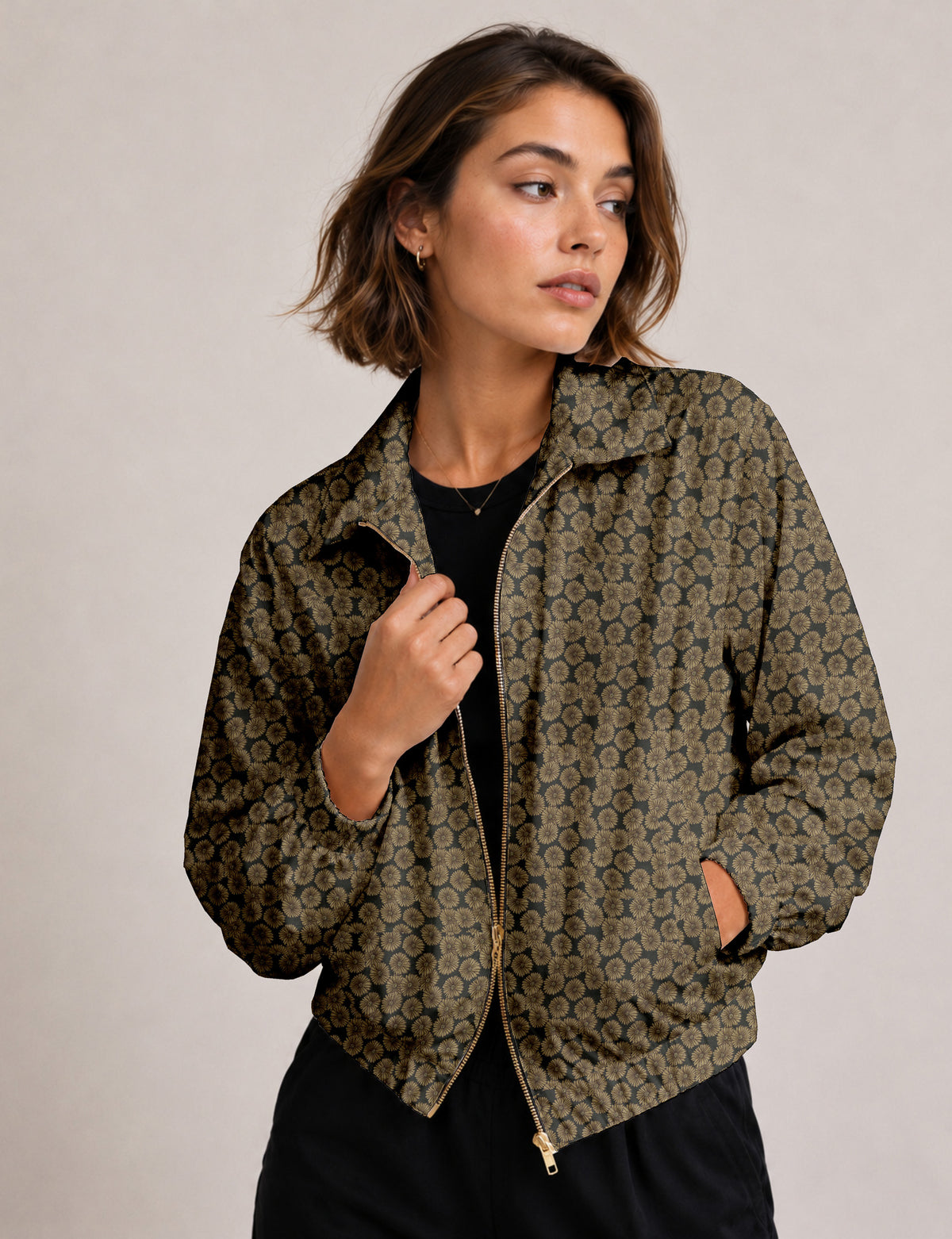 Woman wearing a yellow floral bomber jacket with front zipper, elastic cuffs, and side pockets, shown from front view