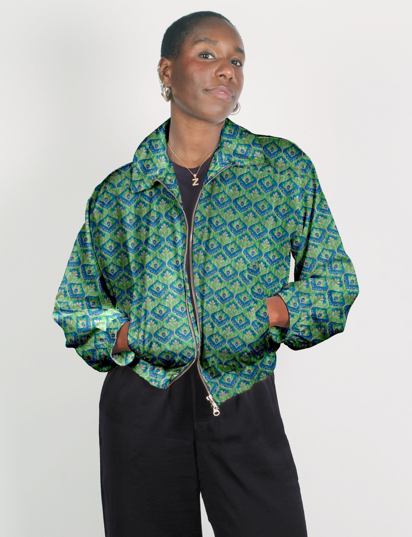 Upcycled Bomber Jacket made from recycled sari materials, featuring a cute cropped shape, elasticated hem and cuffs, and contrast sari print lining. Sustainable apparel promoting eco-friendly fashion and ethical clothing.