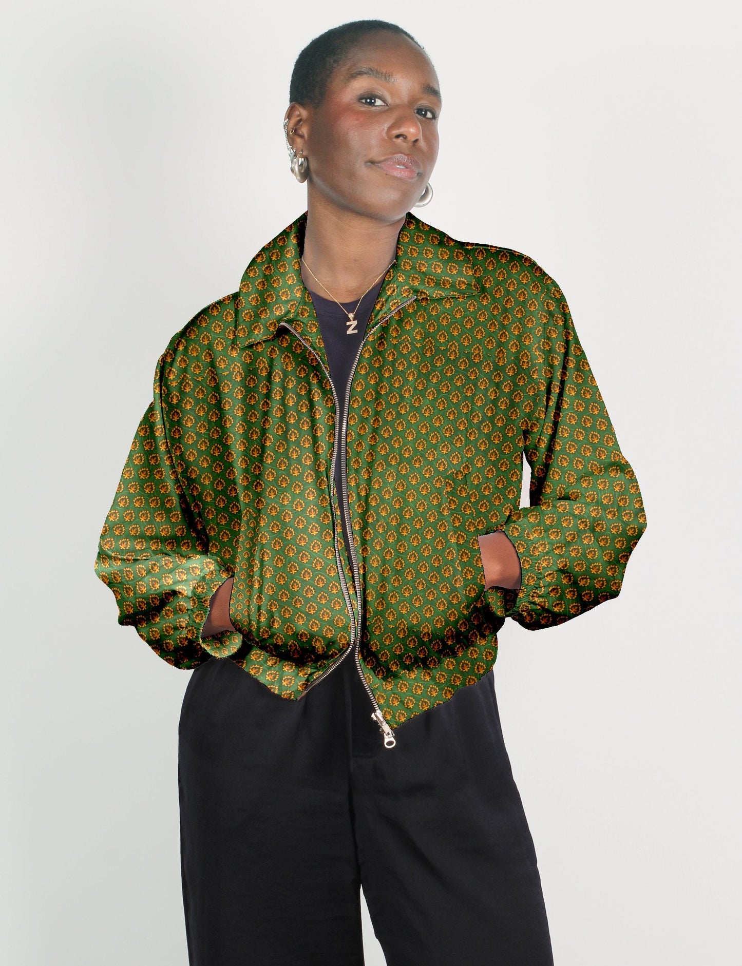 Stylish BOMBER JACKET, an upcycled clothing masterpiece with a cute cropped shape, elasticated details, and detachable metallic zipper. Contrast sari print lining adds a unique touch. Explore sustainable and eco-friendly fashion.