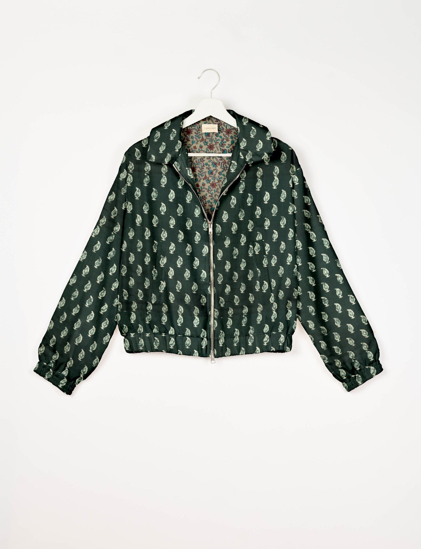 Upcycled Bomber Jacket made from recycled sari materials, featuring a cute cropped shape, elasticated hem and cuffs, and contrast sari print lining. Sustainable apparel promoting eco-friendly fashion and ethical clothing.