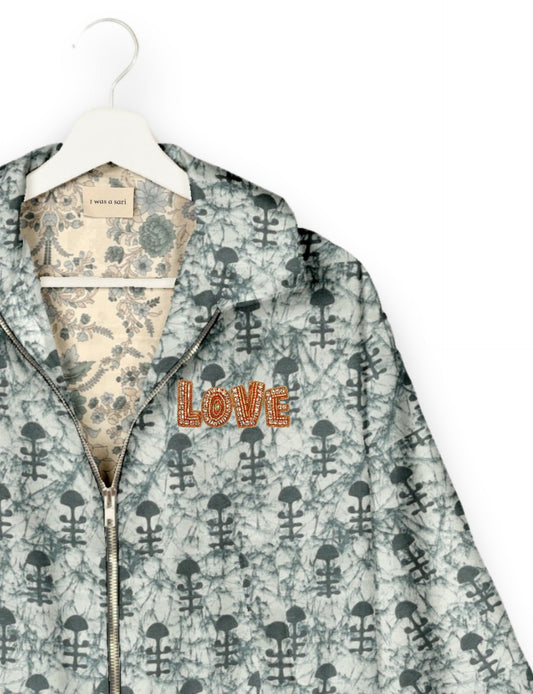 Love Bomber Jacket made from recycled fabric, featuring hand-stitched Aari embroidery. A unique piece of zero-waste clothing, part of the circular fashion movement. Designed with upcycled materials for a stylish yet environmentally friendly clothing choice.