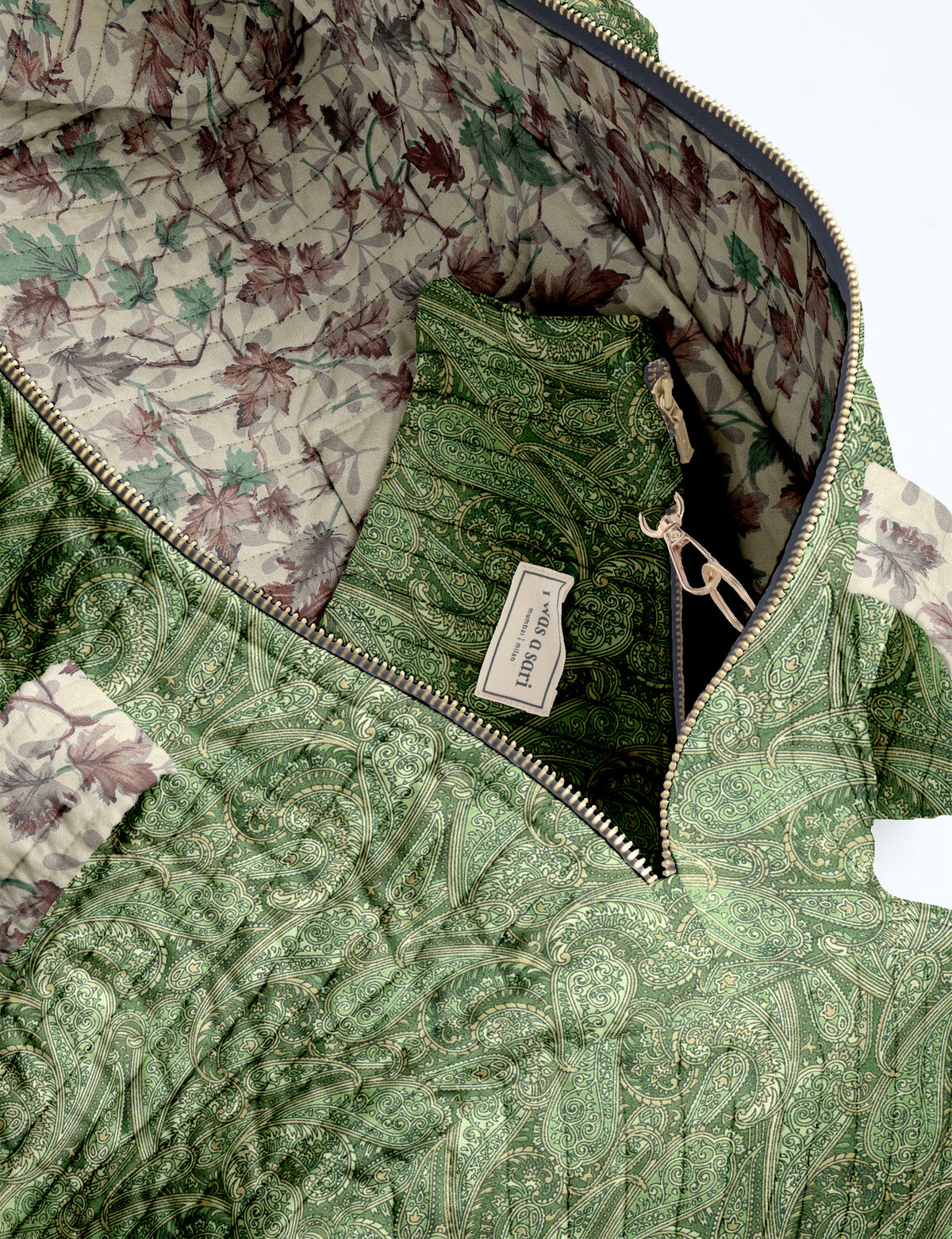 Brown paisley quilted bowling bag with dual handles, front zipper pocket, and "I was a sari" label on front side