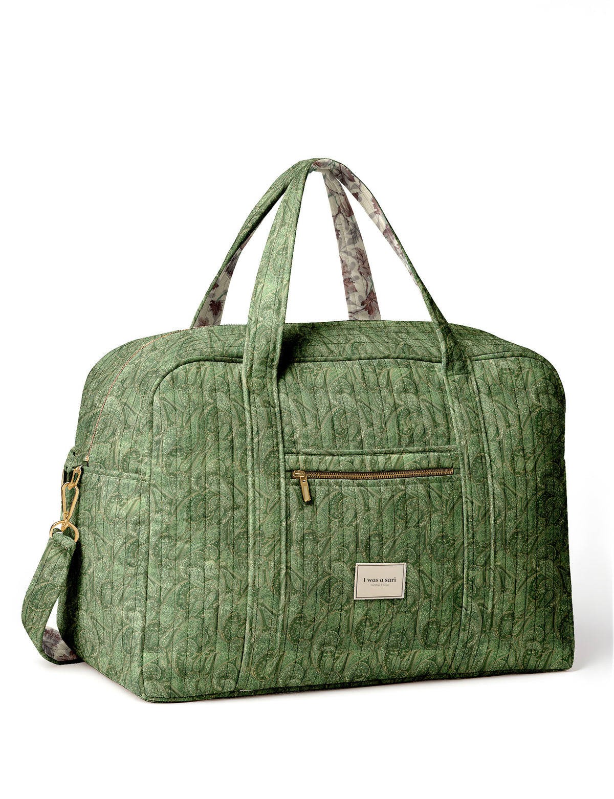 Brown quilted duffle bag with paisley pattern, front zip pocket, dual handles, and label reading "I was a sari"
