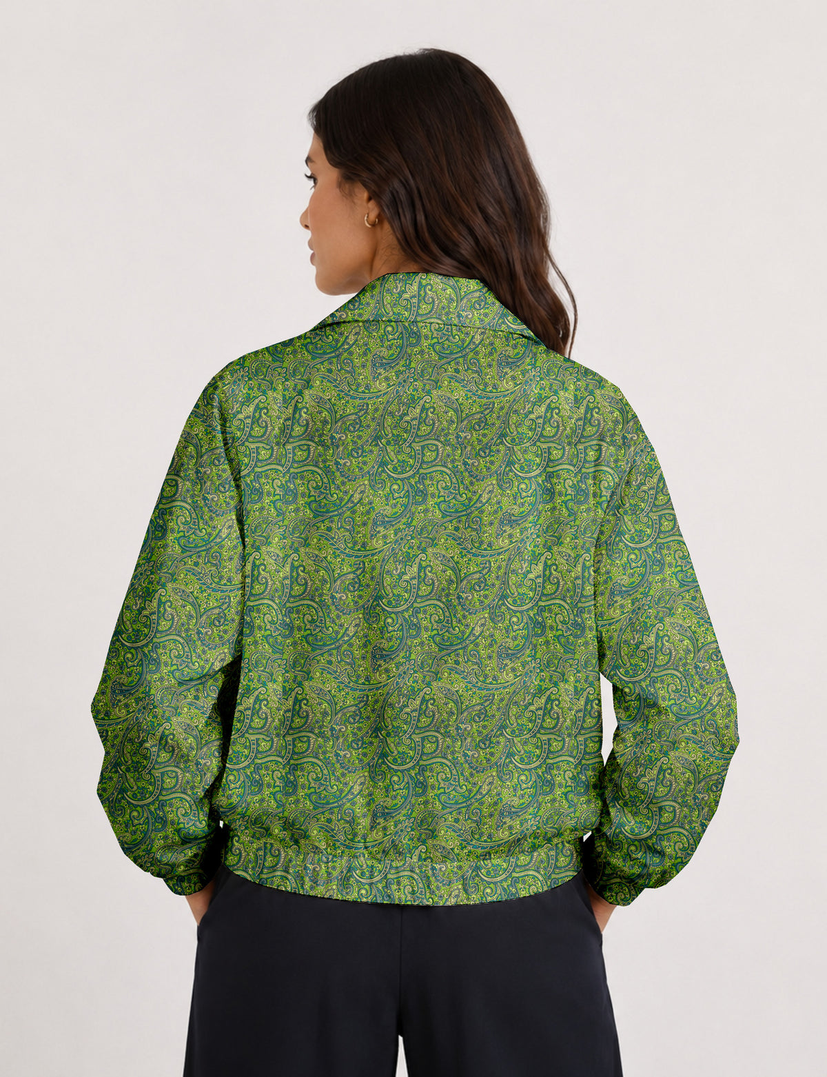 Brown floral bomber jacket with front zipper, elastic cuffs and hem, hanging on white hanger, red floral inner lining visible