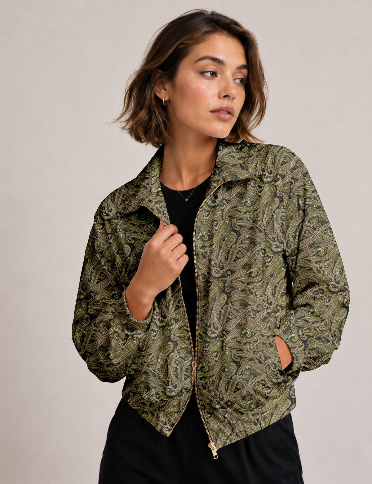 Woman wearing a yellow floral bomber jacket with front zipper, elastic cuffs, and side pockets, shown from front view