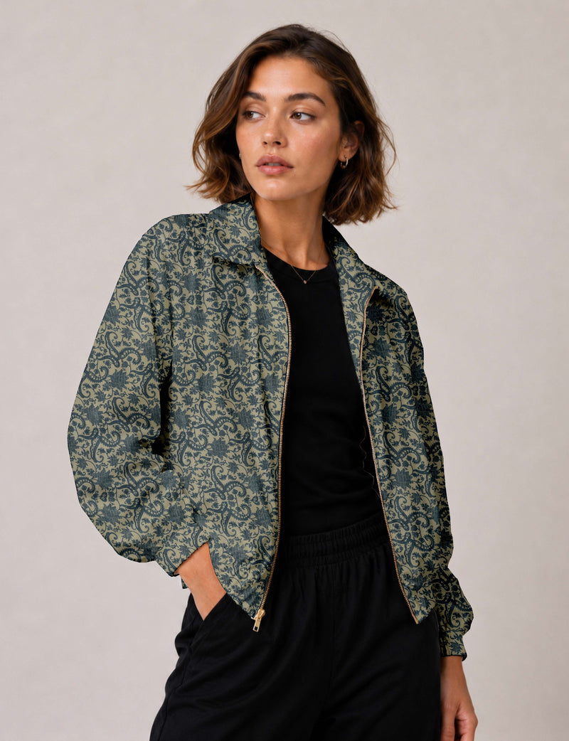 Woman wearing a yellow floral bomber jacket with front zipper, elastic cuffs, and side pockets, shown from front view