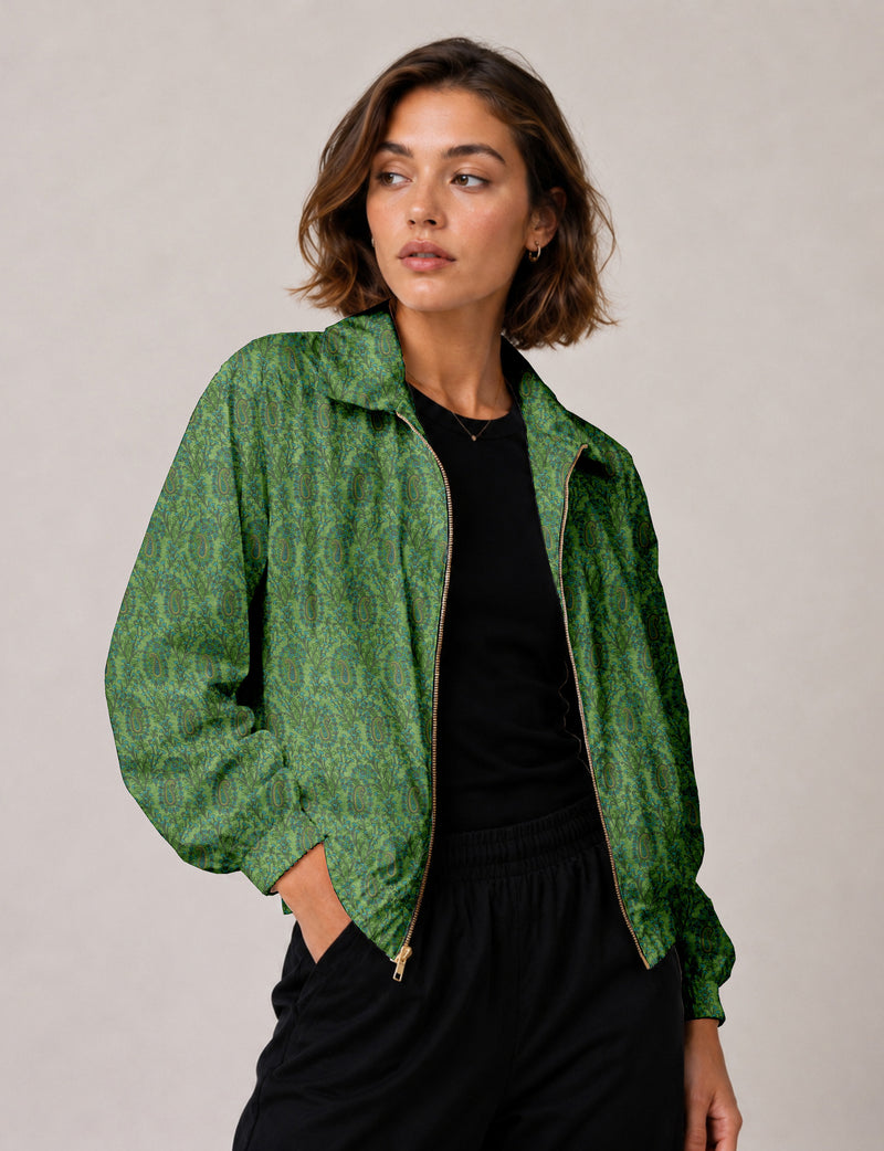 Woman wearing a yellow floral bomber jacket with front zipper, elastic cuffs, and side pockets, shown from front view