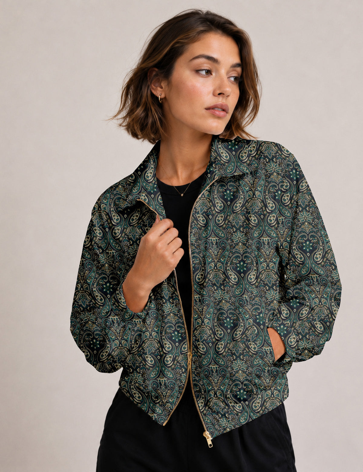 Brown floral bomber jacket with front zipper, elastic cuffs and hem, hanging on white hanger, red floral inner lining visible