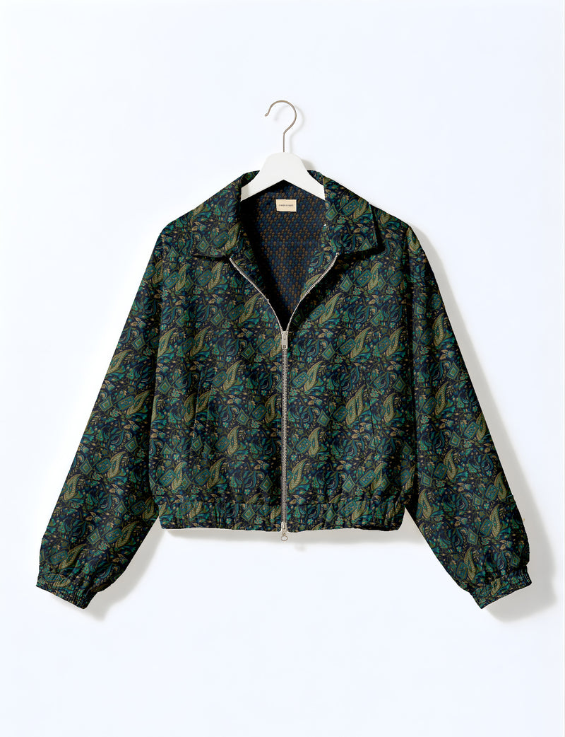 Woman wearing a yellow floral bomber jacket with front zipper, elastic cuffs, and side pockets, shown from front view
