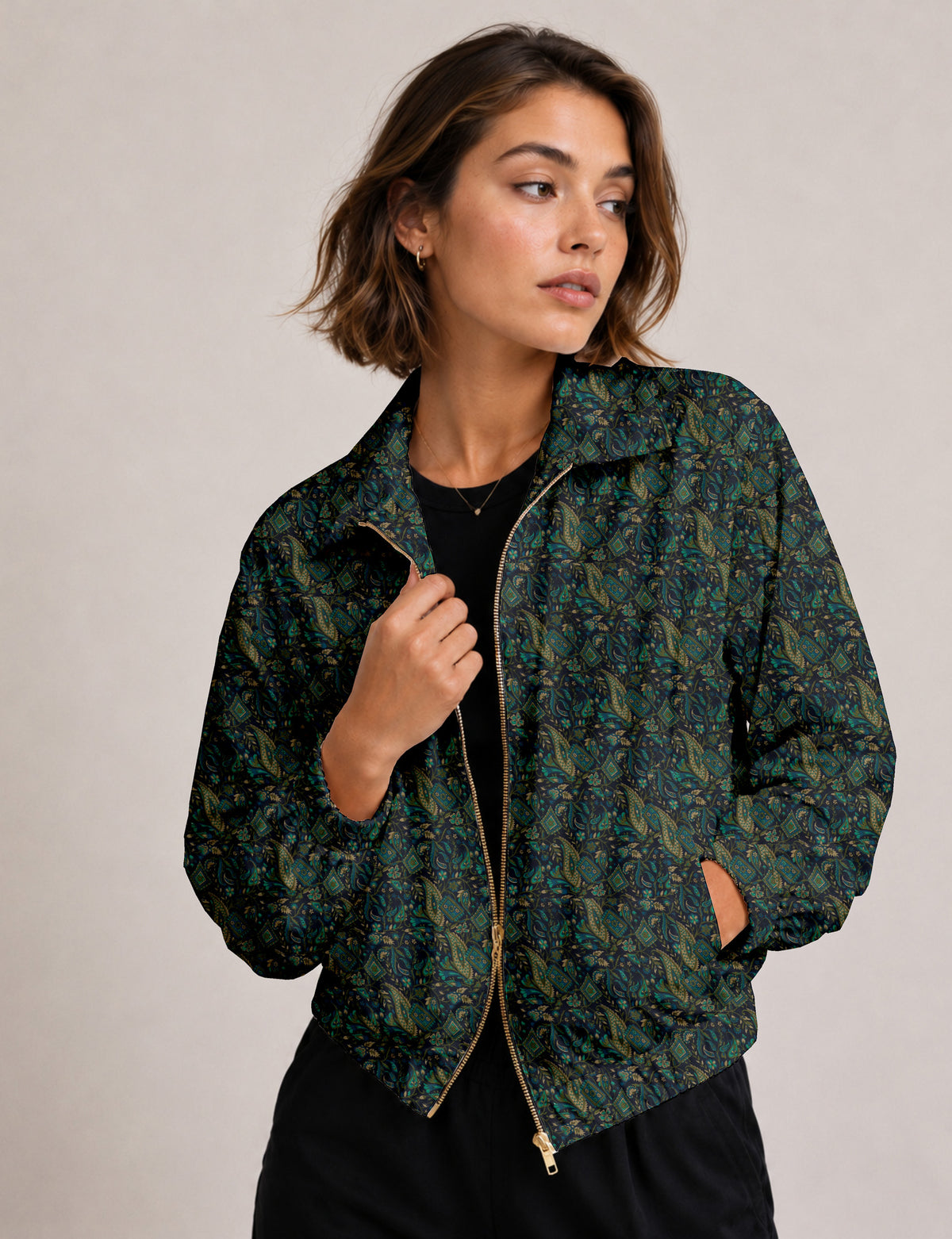 Brown floral bomber jacket with front zipper, elastic cuffs and hem, hanging on white hanger, red floral inner lining visible