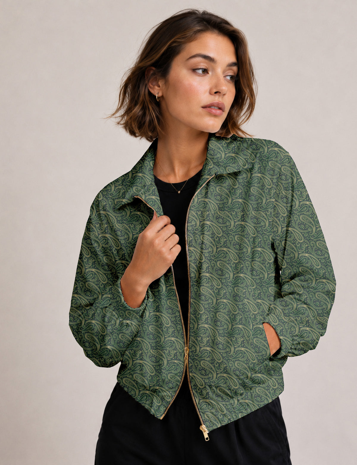 Woman wearing a yellow floral bomber jacket with front zipper, elastic cuffs, and side pockets, shown from front view