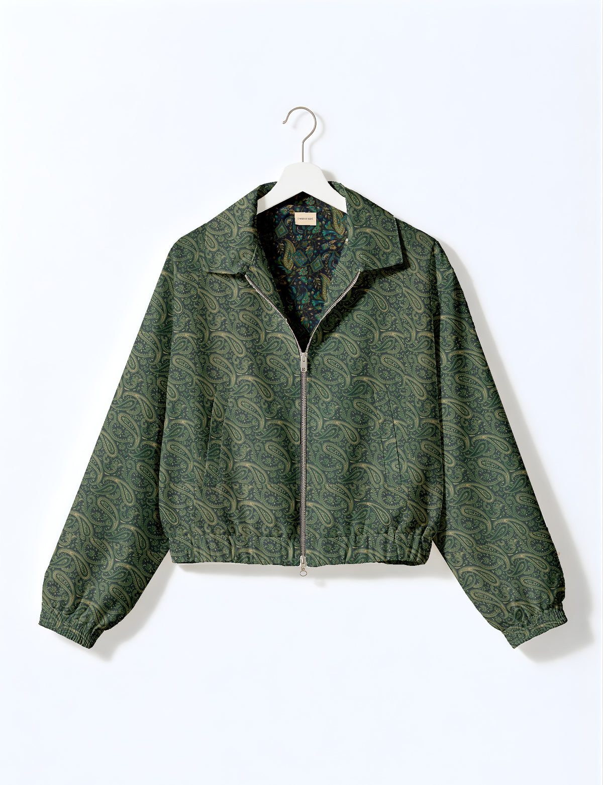 Brown floral bomber jacket with front zipper, elastic cuffs and hem, hanging on white hanger, red floral inner lining visible