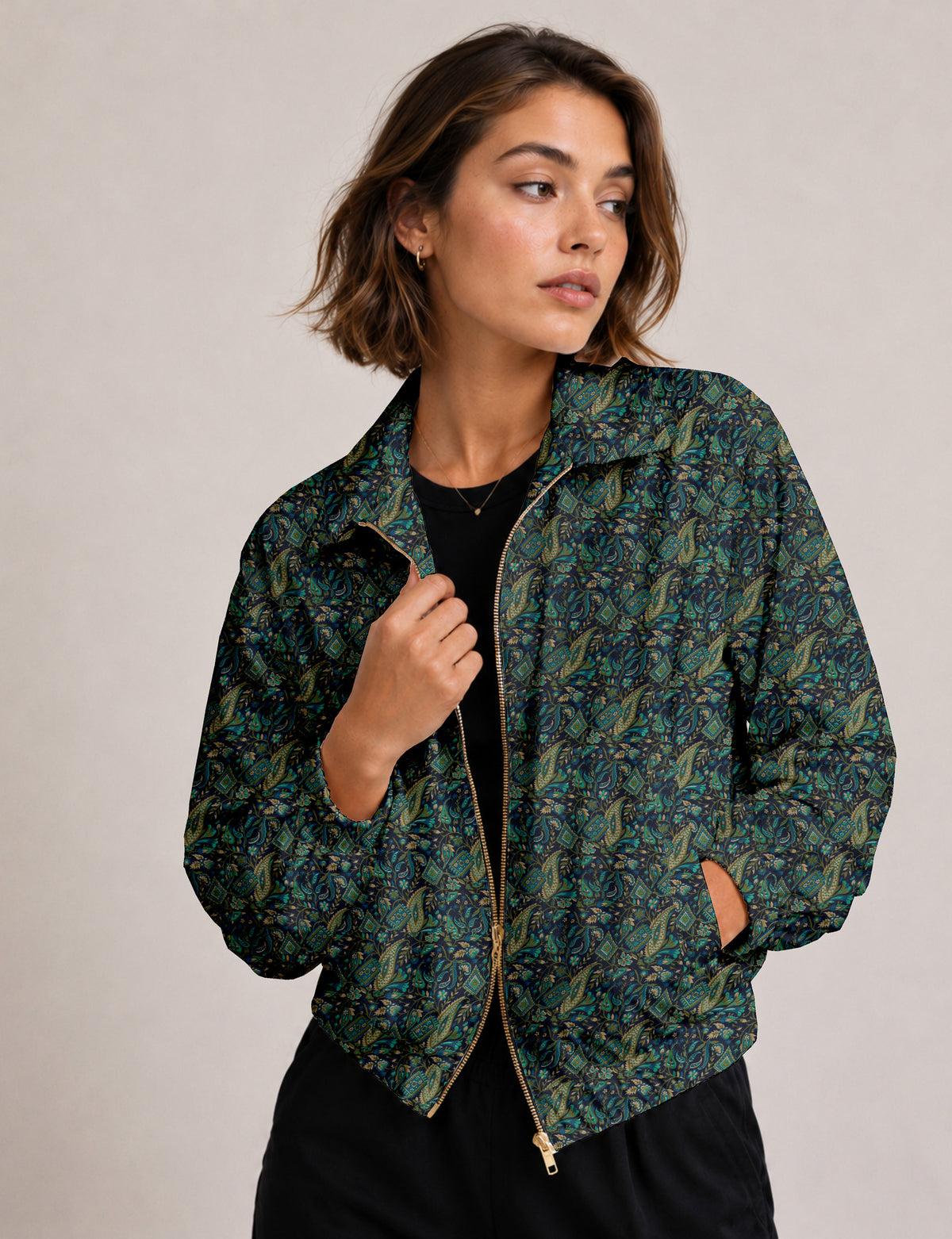 Brown floral bomber jacket with front zipper, elastic cuffs and hem, hanging on white hanger, red floral inner lining visible