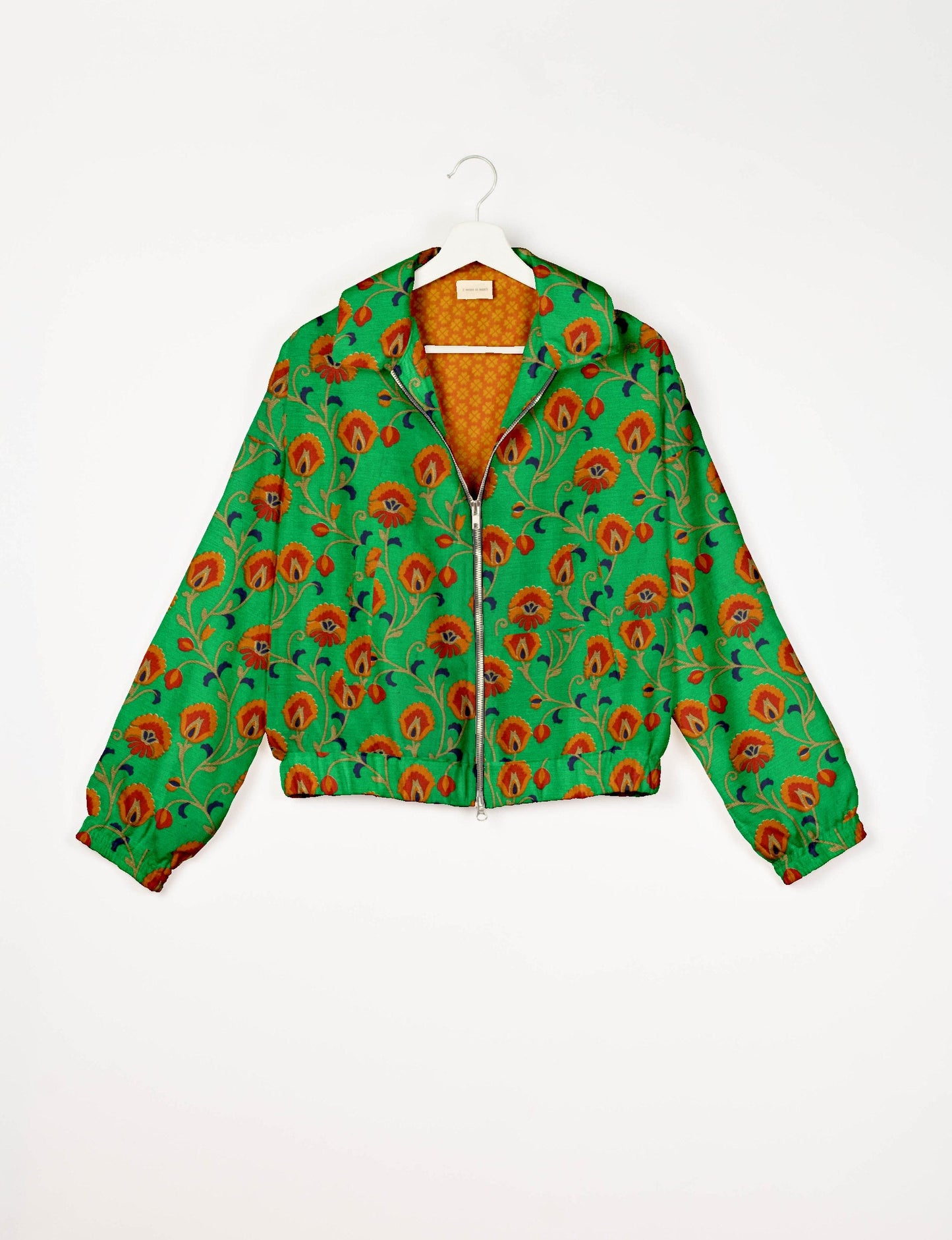 Upcycled Bomber Jacket made from recycled sari materials, featuring a cute cropped shape, elasticated hem and cuffs, and contrast sari print lining. Sustainable apparel promoting eco-friendly fashion and ethical clothing.