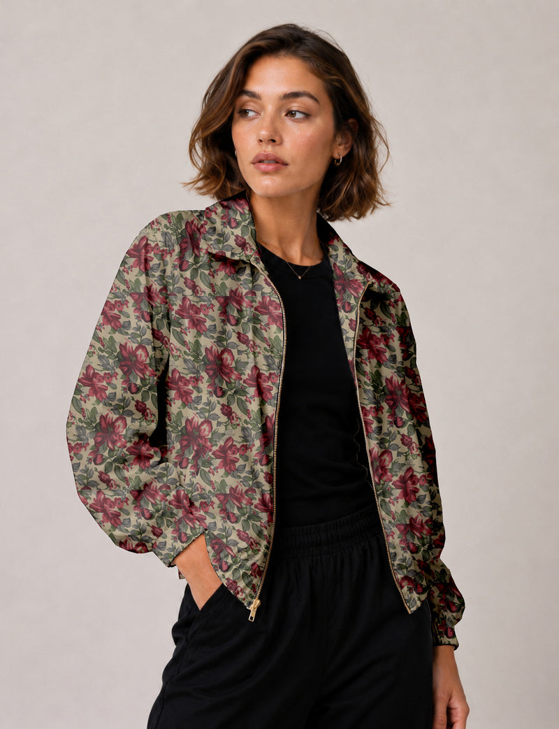 Woman wearing a yellow floral bomber jacket with front zipper, elastic cuffs, and side pockets, shown from front view