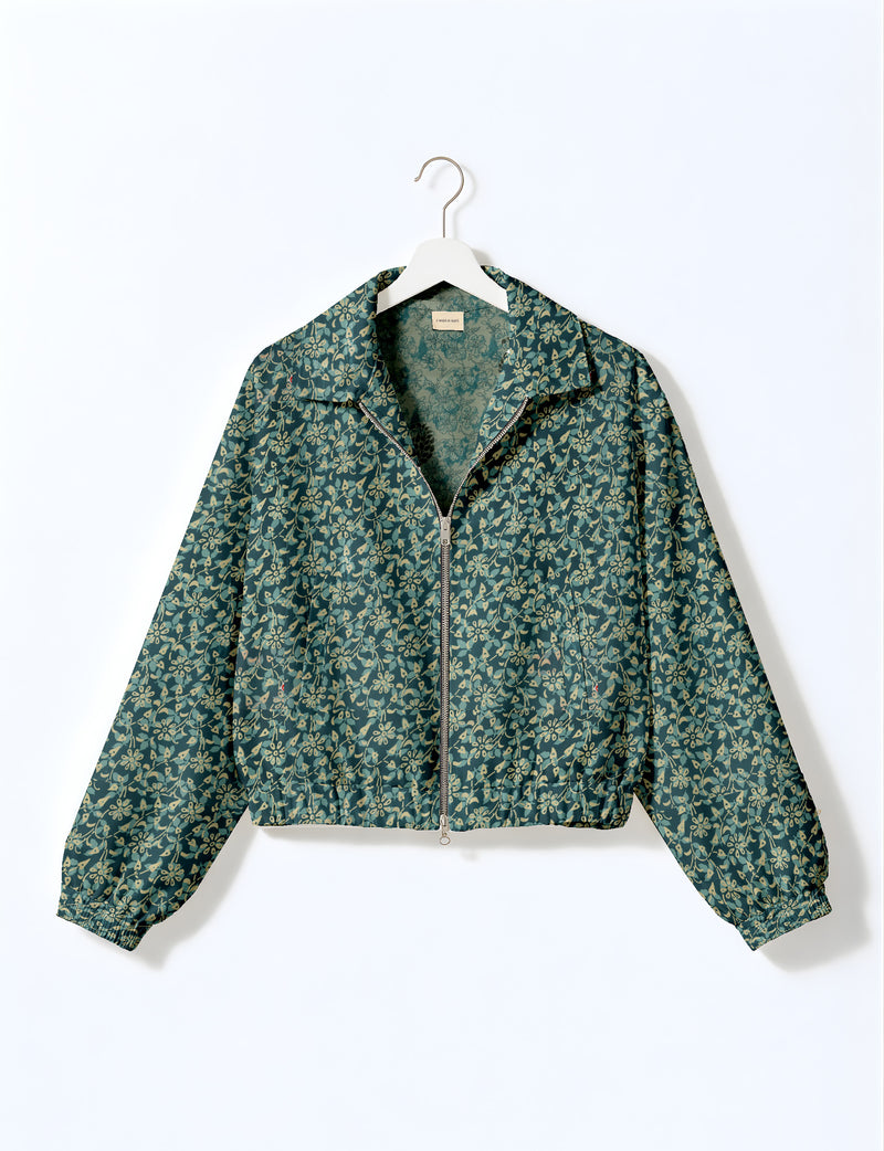 Brown floral bomber jacket with front zipper, elastic cuffs and hem, hanging on white hanger, red floral inner lining visible