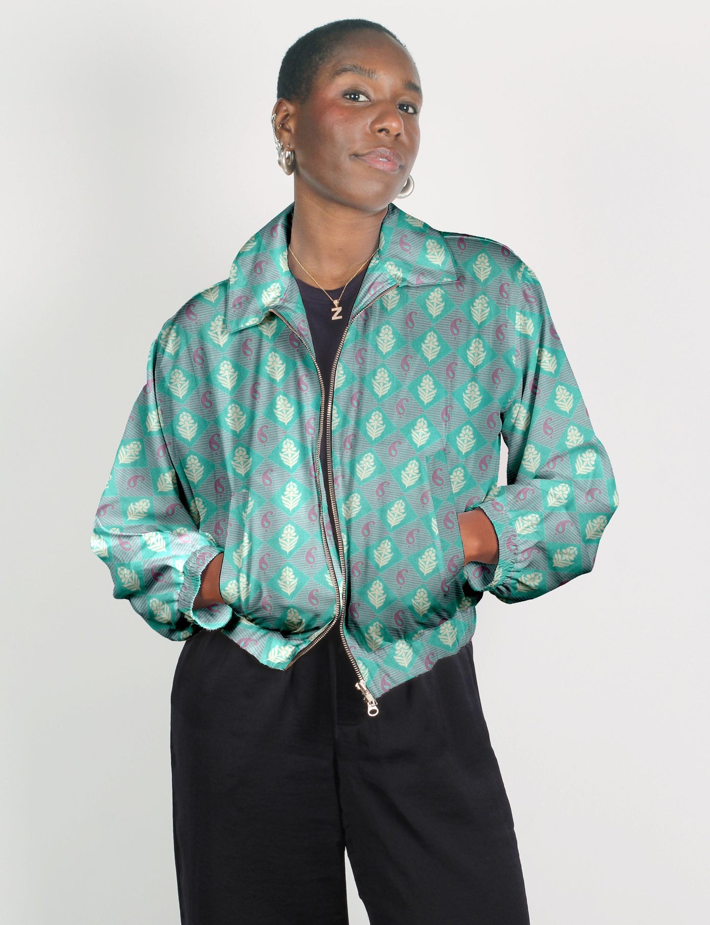 Upcycled Bomber Jacket made from recycled sari materials, featuring a cute cropped shape, elasticated hem and cuffs, and contrast sari print lining. Sustainable apparel promoting eco-friendly fashion and ethical clothing.