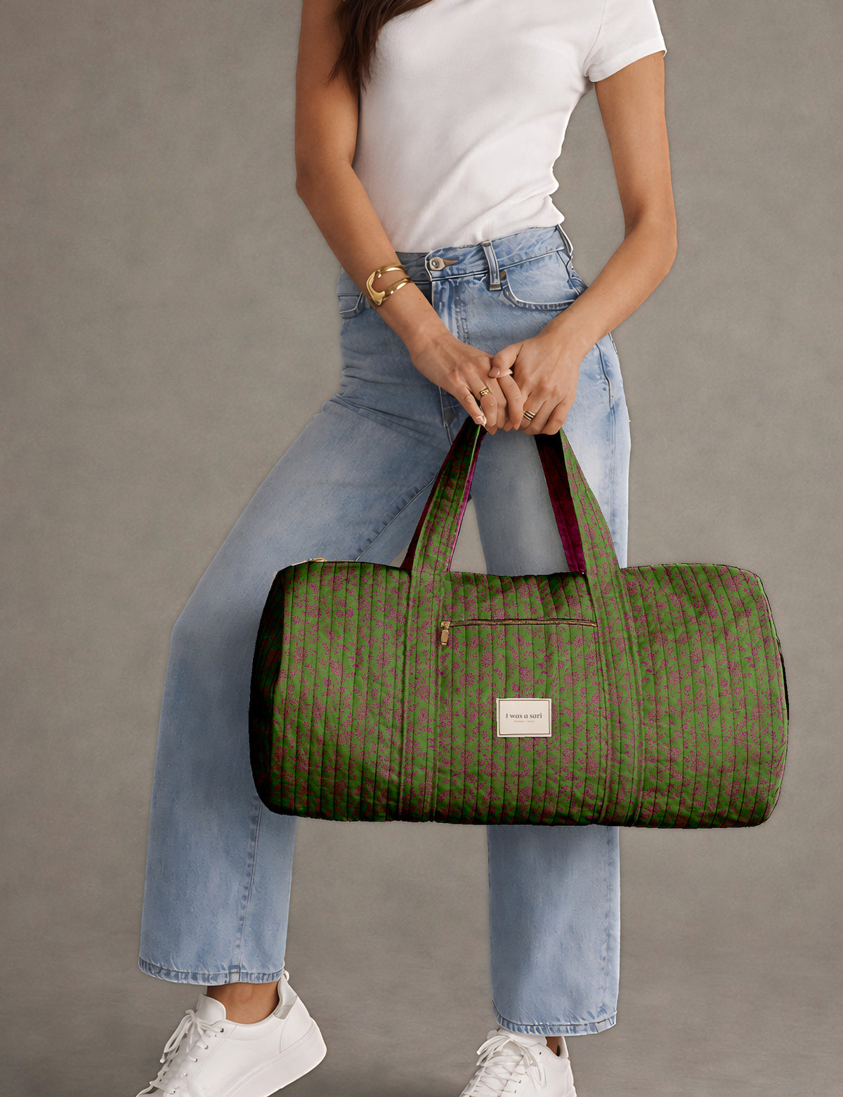 Brown paisley quilted bowling bag with dual handles, front zipper pocket, and "I was a sari" label on front side
