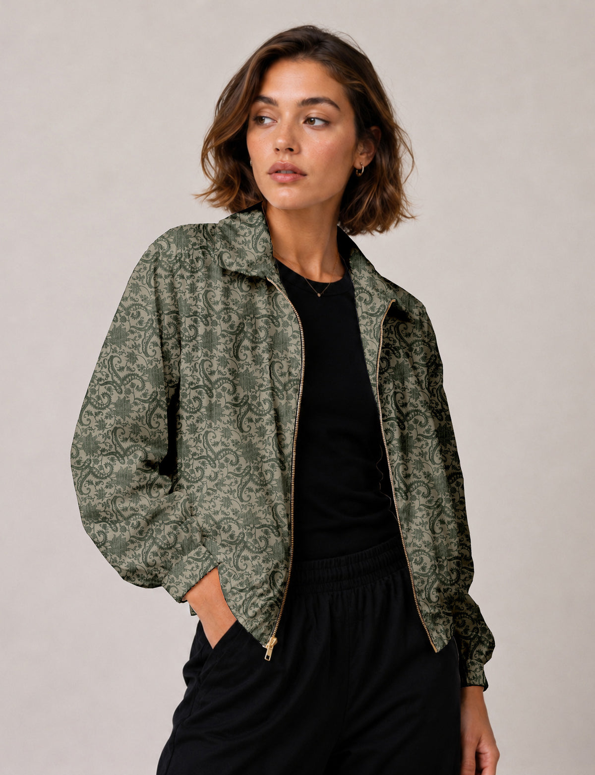 Brown floral bomber jacket with front zipper, elastic cuffs and hem, hanging on white hanger, red floral inner lining visible