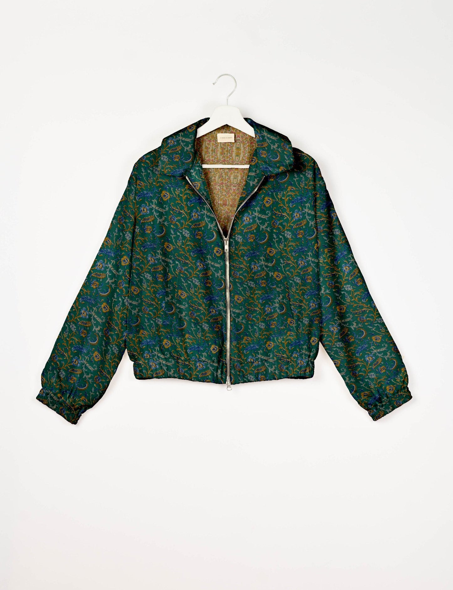 Upcycled Bomber Jacket made from recycled sari materials, featuring a cute cropped shape, elasticated hem and cuffs, and contrast sari print lining. Sustainable apparel promoting eco-friendly fashion and ethical clothing.