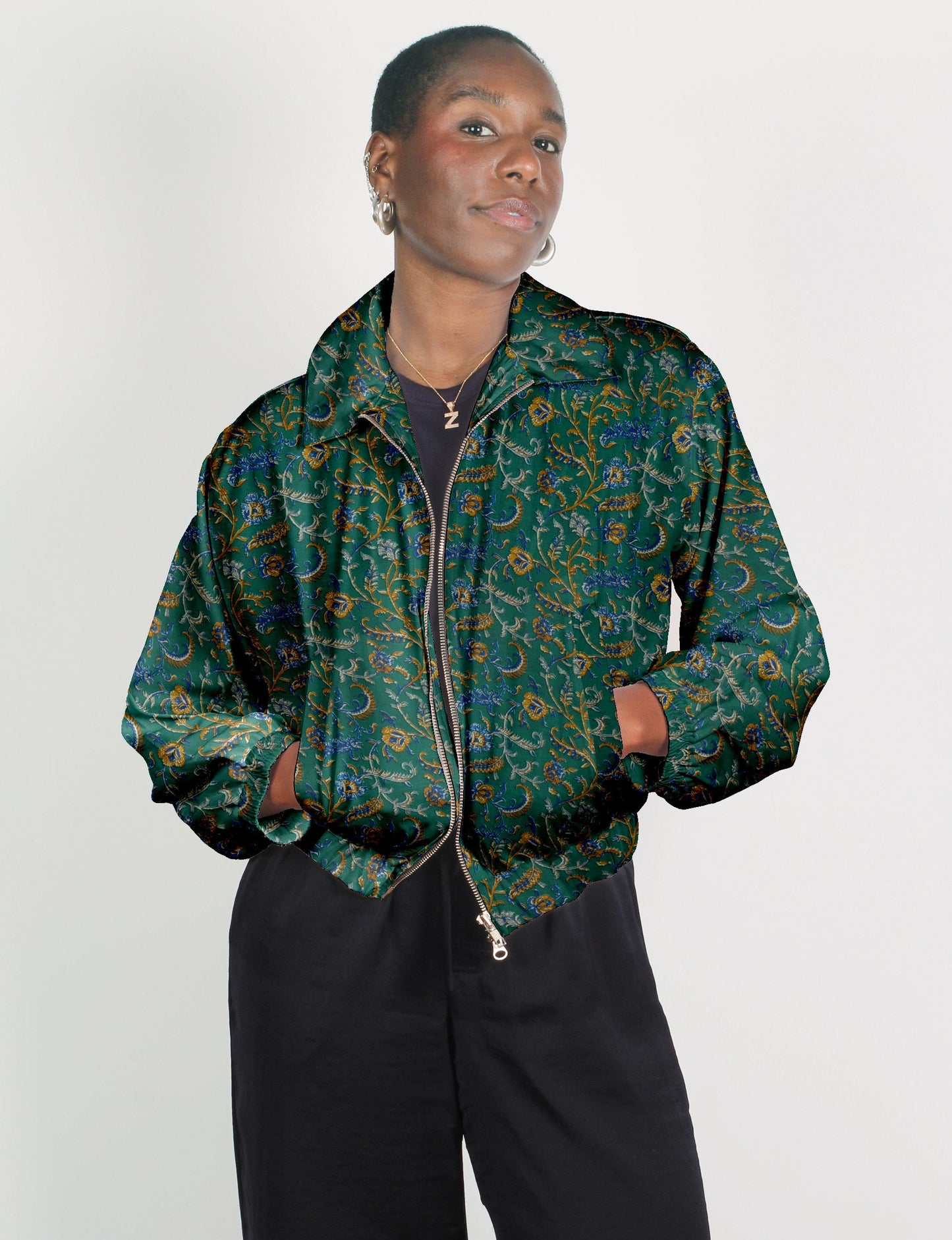 Upcycled Bomber Jacket made from recycled sari materials, featuring a cute cropped shape, elasticated hem and cuffs, and contrast sari print lining. Sustainable apparel promoting eco-friendly fashion and ethical clothing.