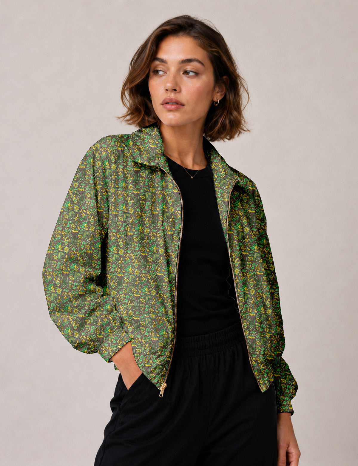 Brown floral bomber jacket with front zipper, elastic cuffs and hem, hanging on white hanger, red floral inner lining visible