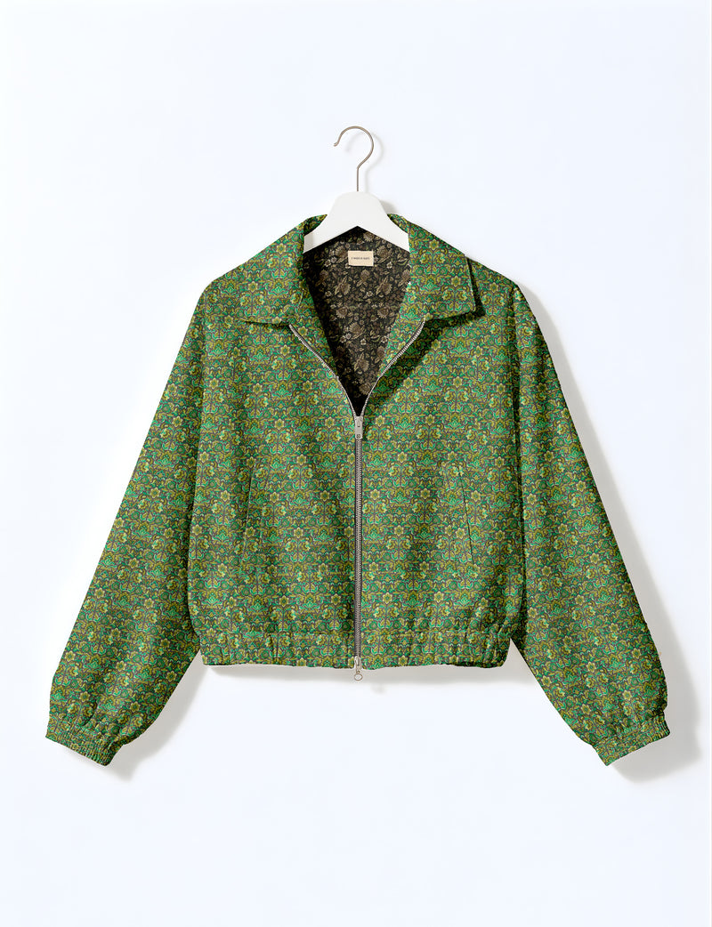 Woman wearing a yellow floral bomber jacket with front zipper, elastic cuffs, and side pockets, shown from front view