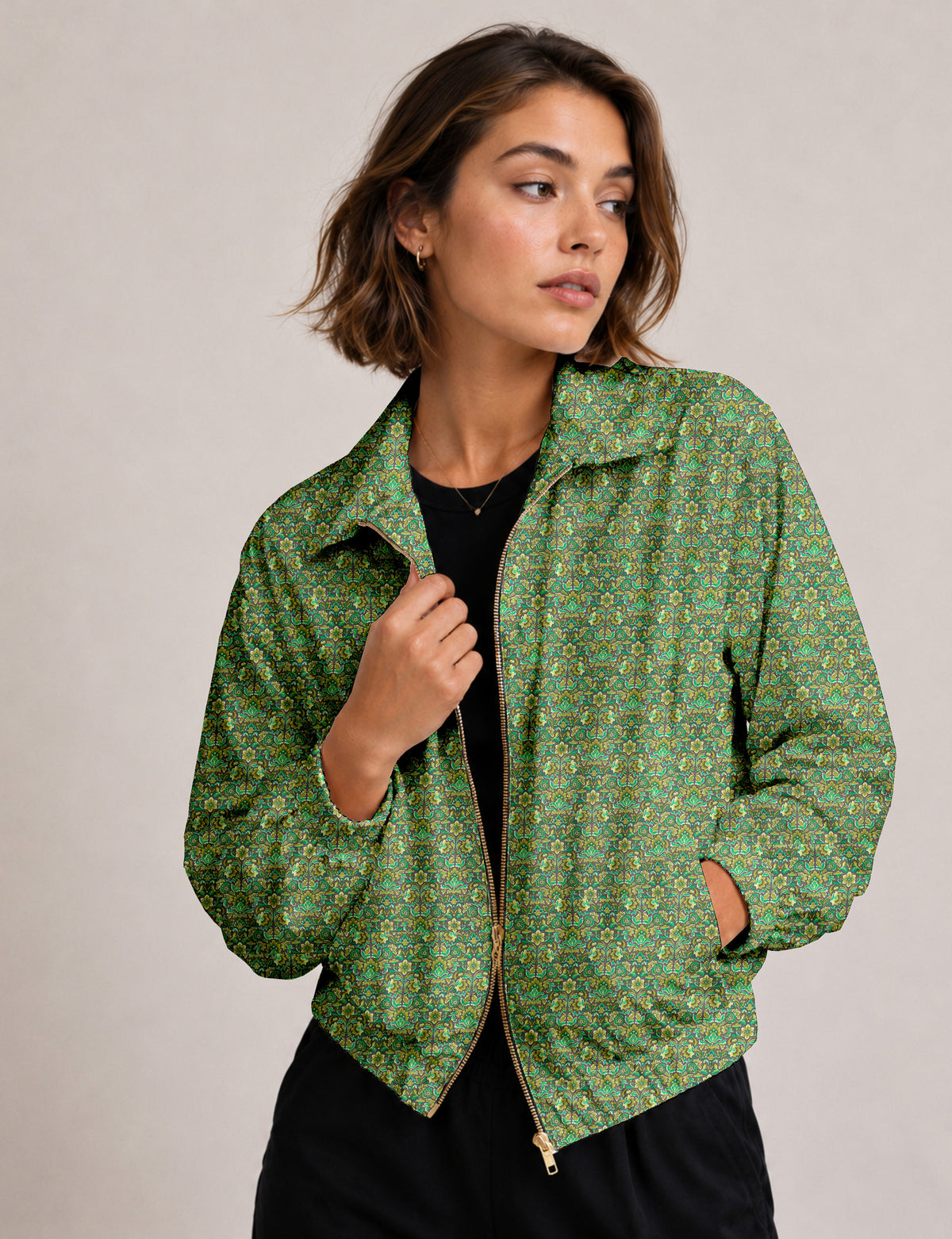 Brown floral bomber jacket with front zipper, elastic cuffs and hem, hanging on white hanger, red floral inner lining visible