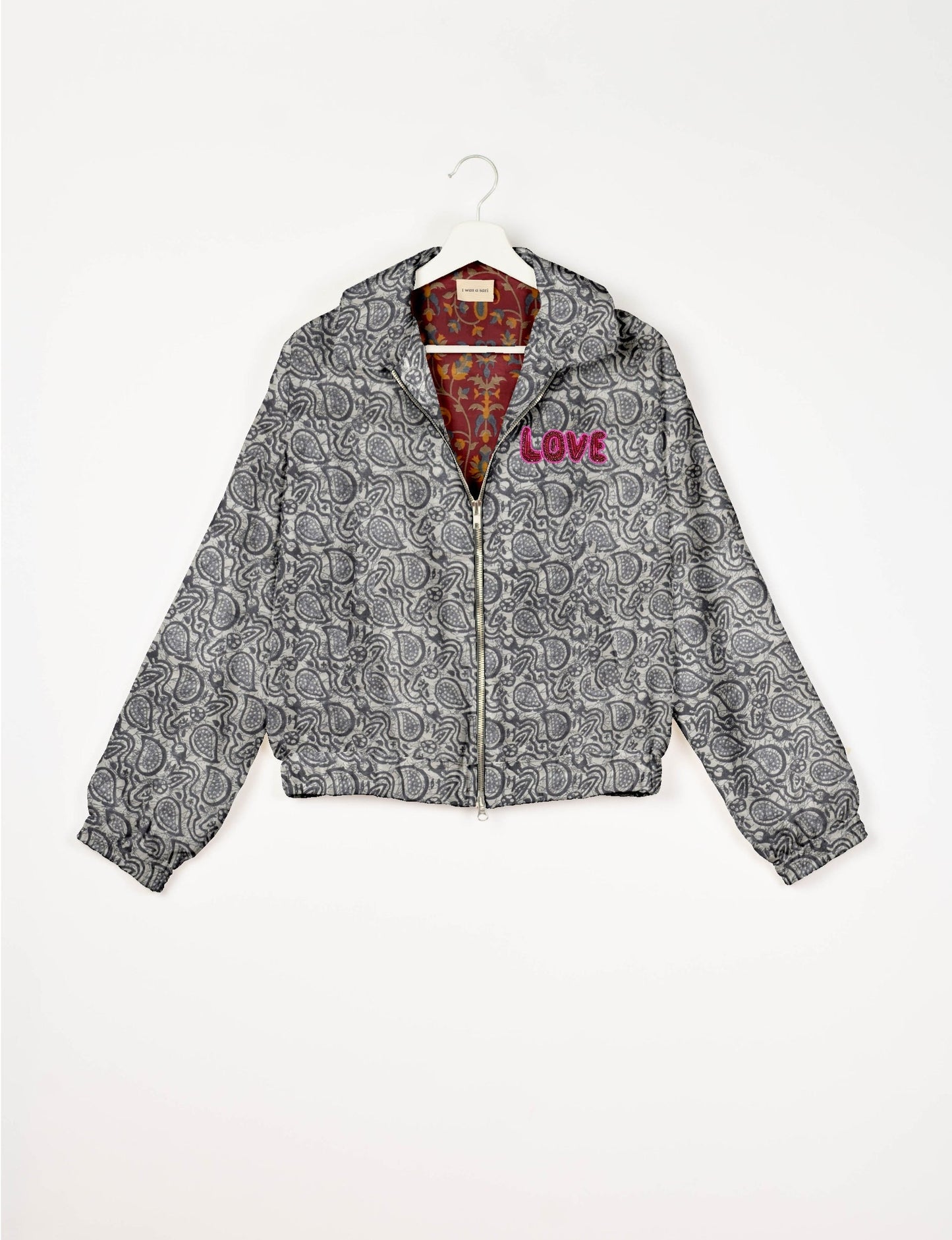 Love Bomber Jacket made from recycled fabric, featuring hand-stitched Aari embroidery. A unique piece of zero-waste clothing, part of the circular fashion movement. Designed with upcycled materials for a stylish yet environmentally friendly clothing choice.