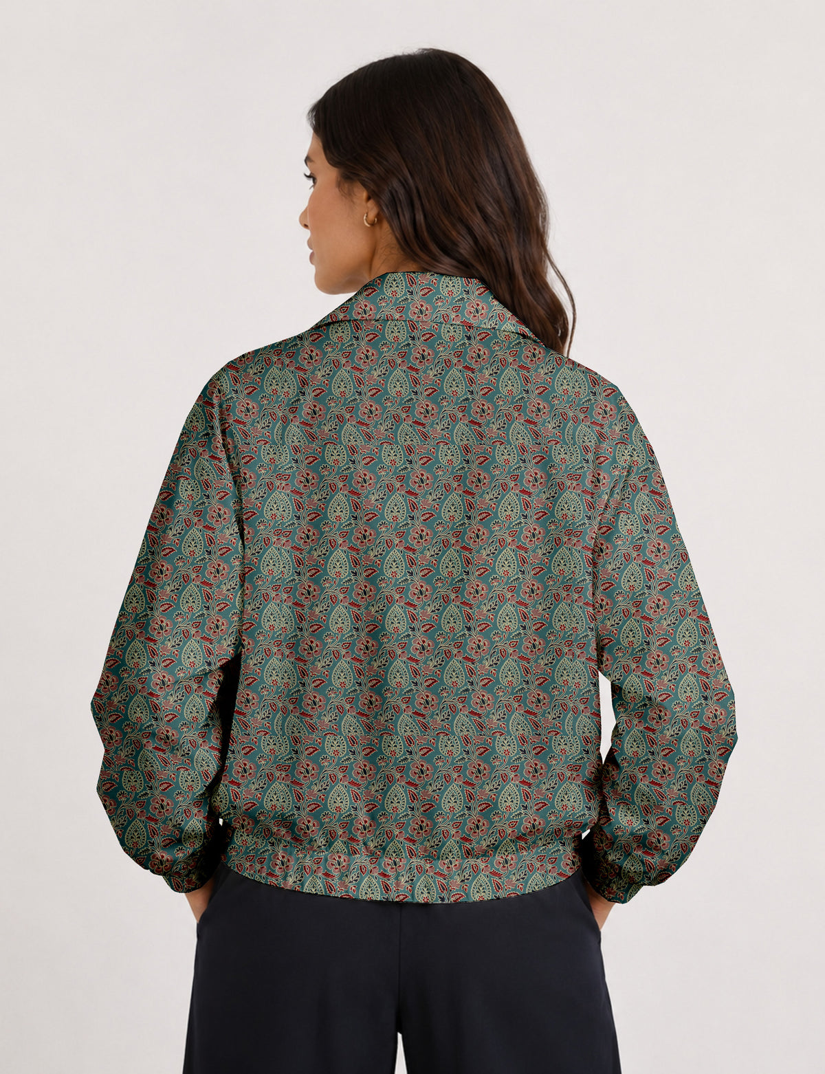 Woman wearing a yellow floral bomber jacket with front zipper, elastic cuffs, and side pockets, shown from front view