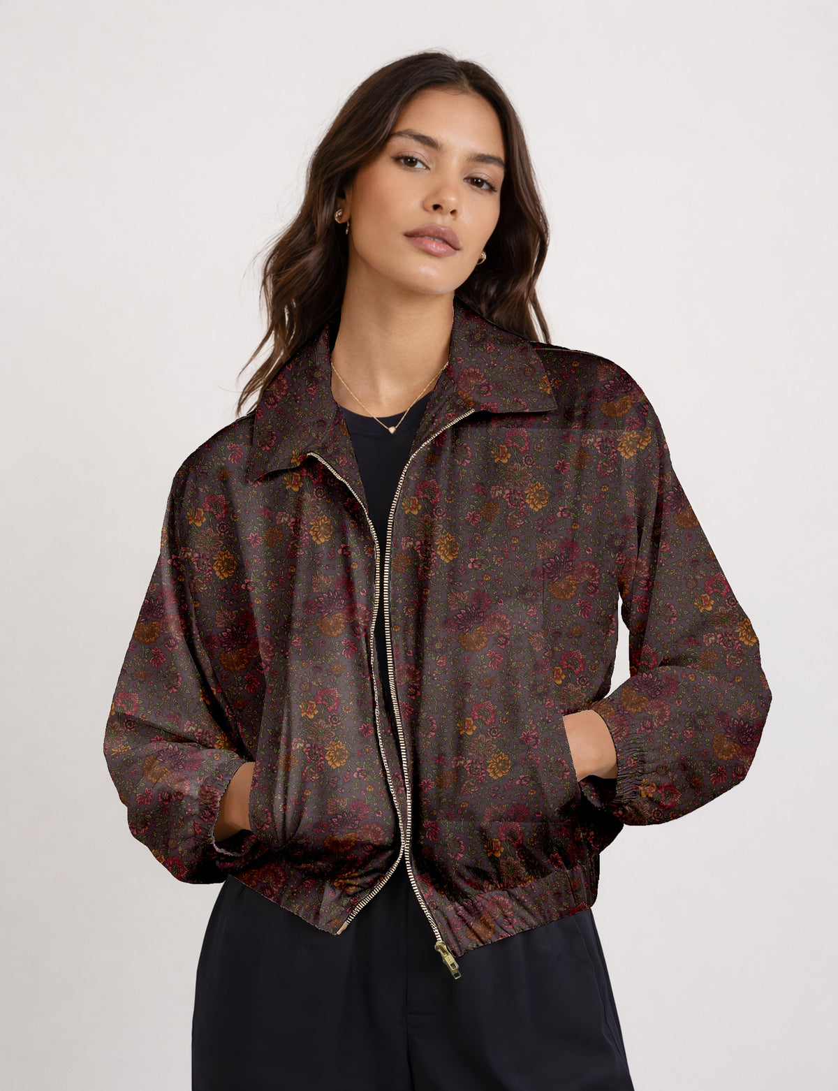 Woman wearing a yellow floral bomber jacket with front zipper, elastic cuffs, and side pockets, shown from front view